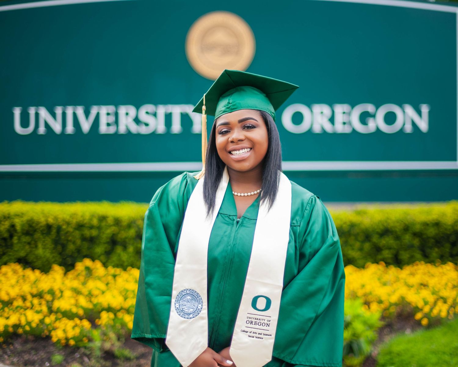 Senior portrait at University of Oregon sign — graduation photographer Bay Area