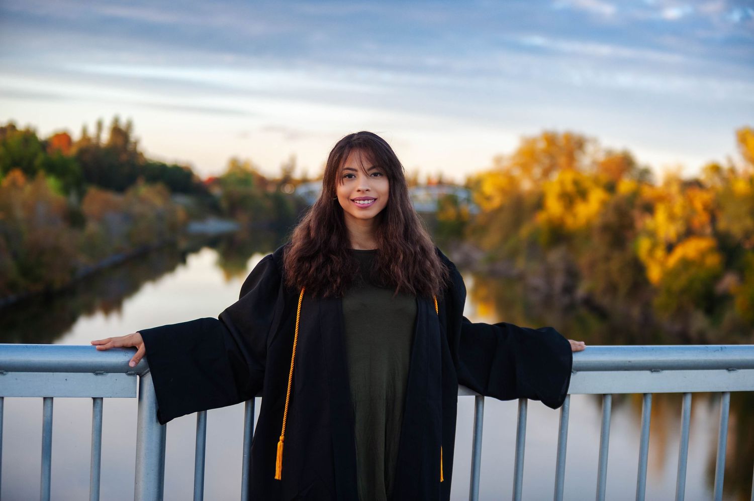 Senior portrait on bridge at golden hour — outdoor graduation photography Bay Area