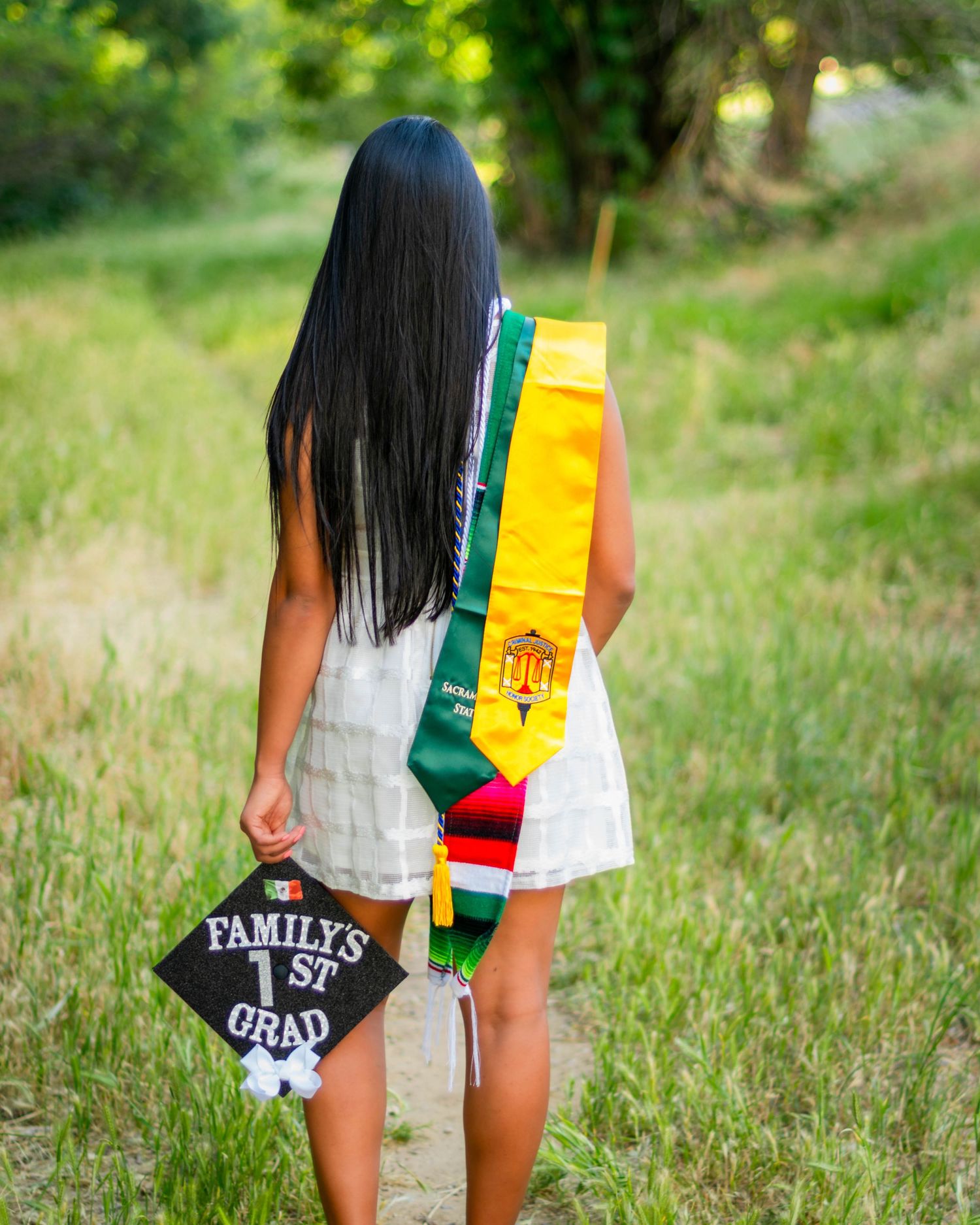 Artistic senior portrait — graduate walking in cap and gown outdoors, Bay Area photographer