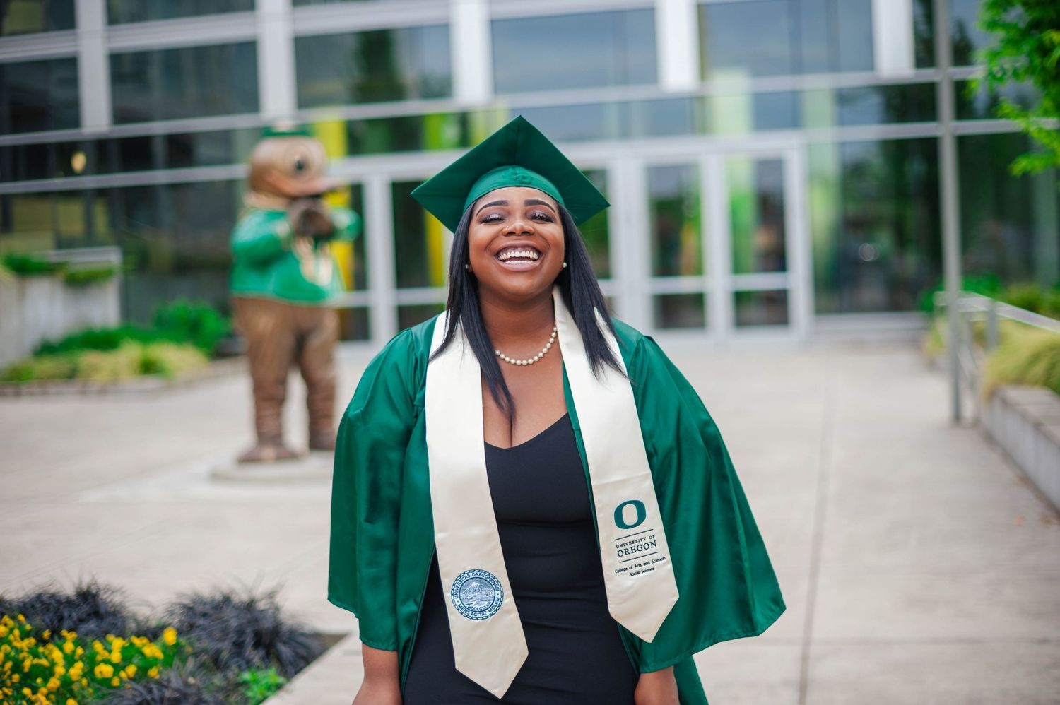 Senior portrait laughing on campus — authentic joyful graduation photography Bay Area