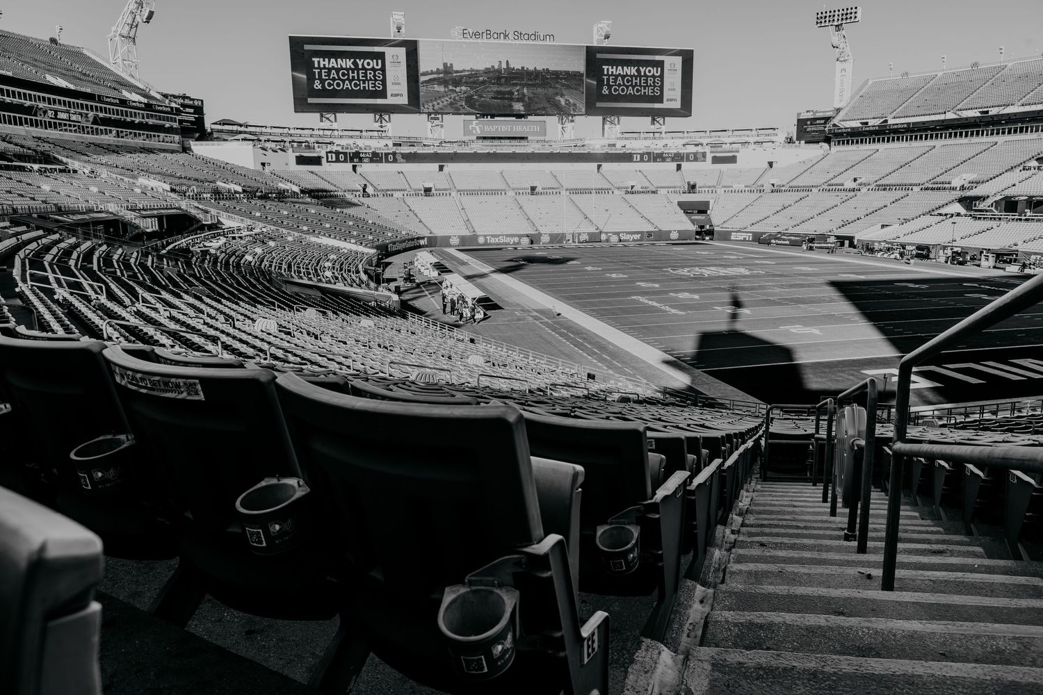 Panoramic view of an empty football stadium with rows of seats stretching into the distance.