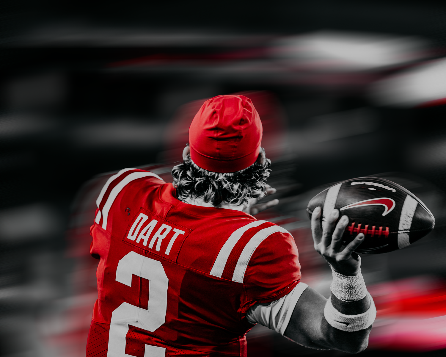 Close-up of red football jersey details against black and white background.