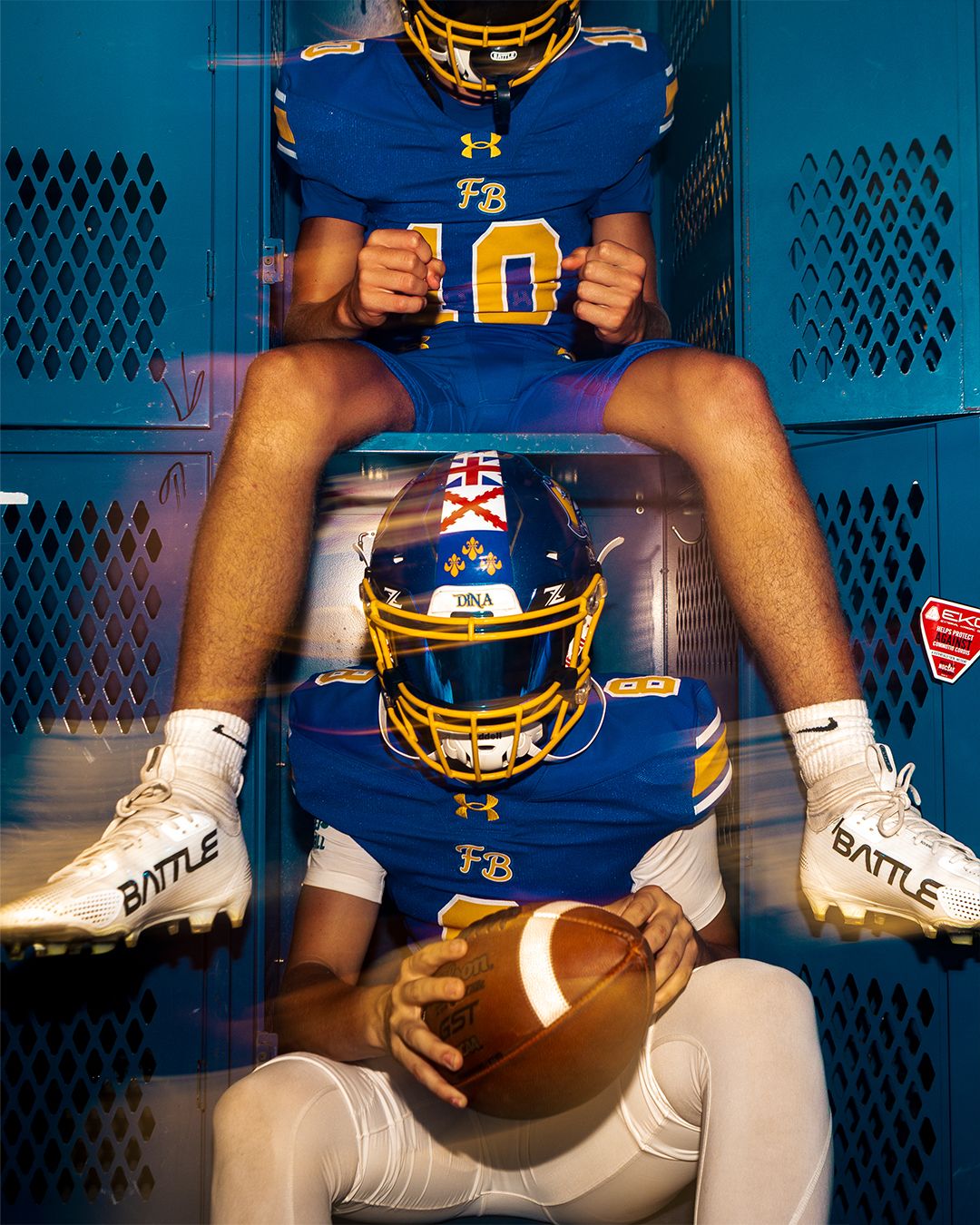 Close-up of football player's uniform and equipment in blue locker room setting.