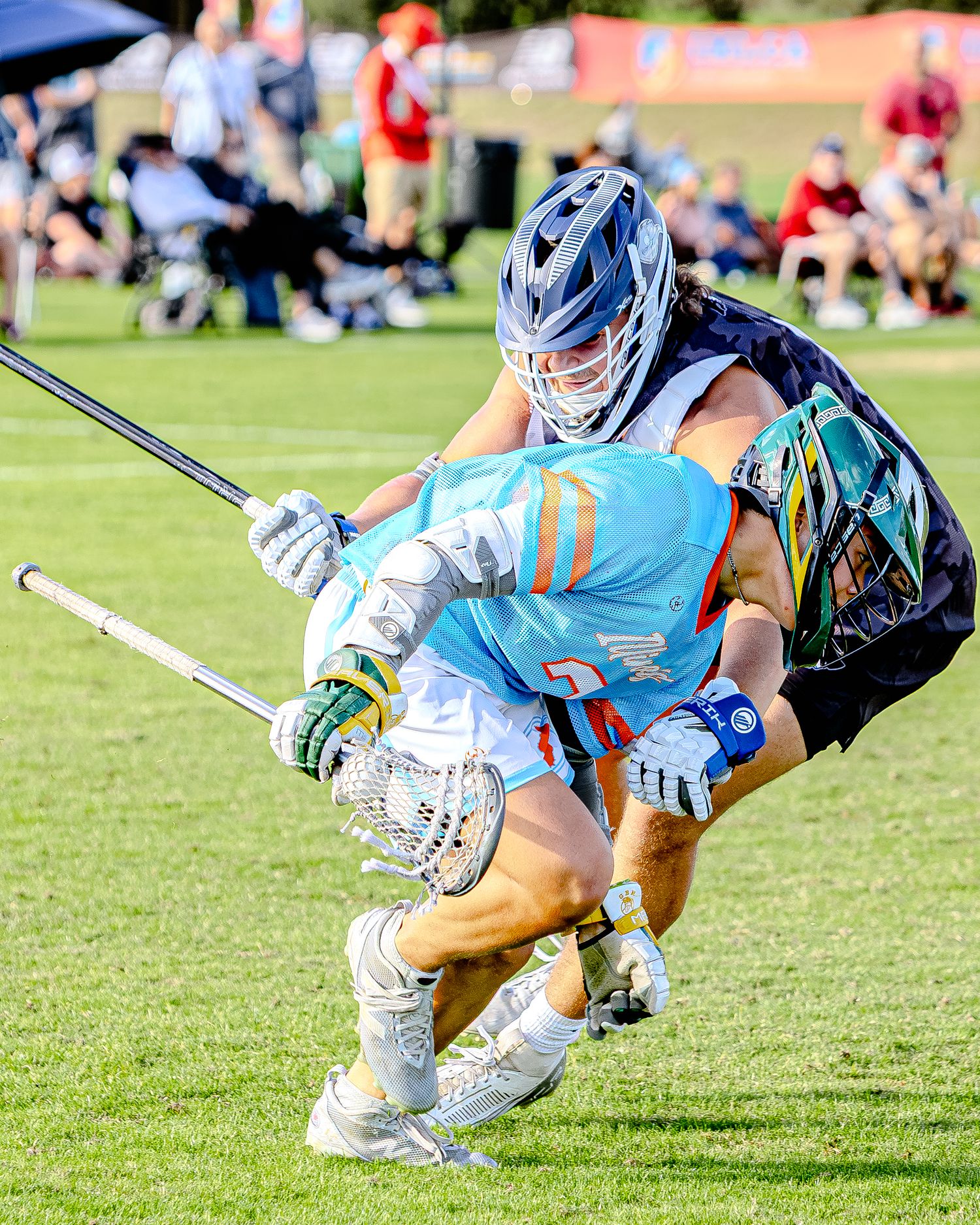 Sequence of lacrosse players diving and stretching for the ball in blue uniforms on grass field.