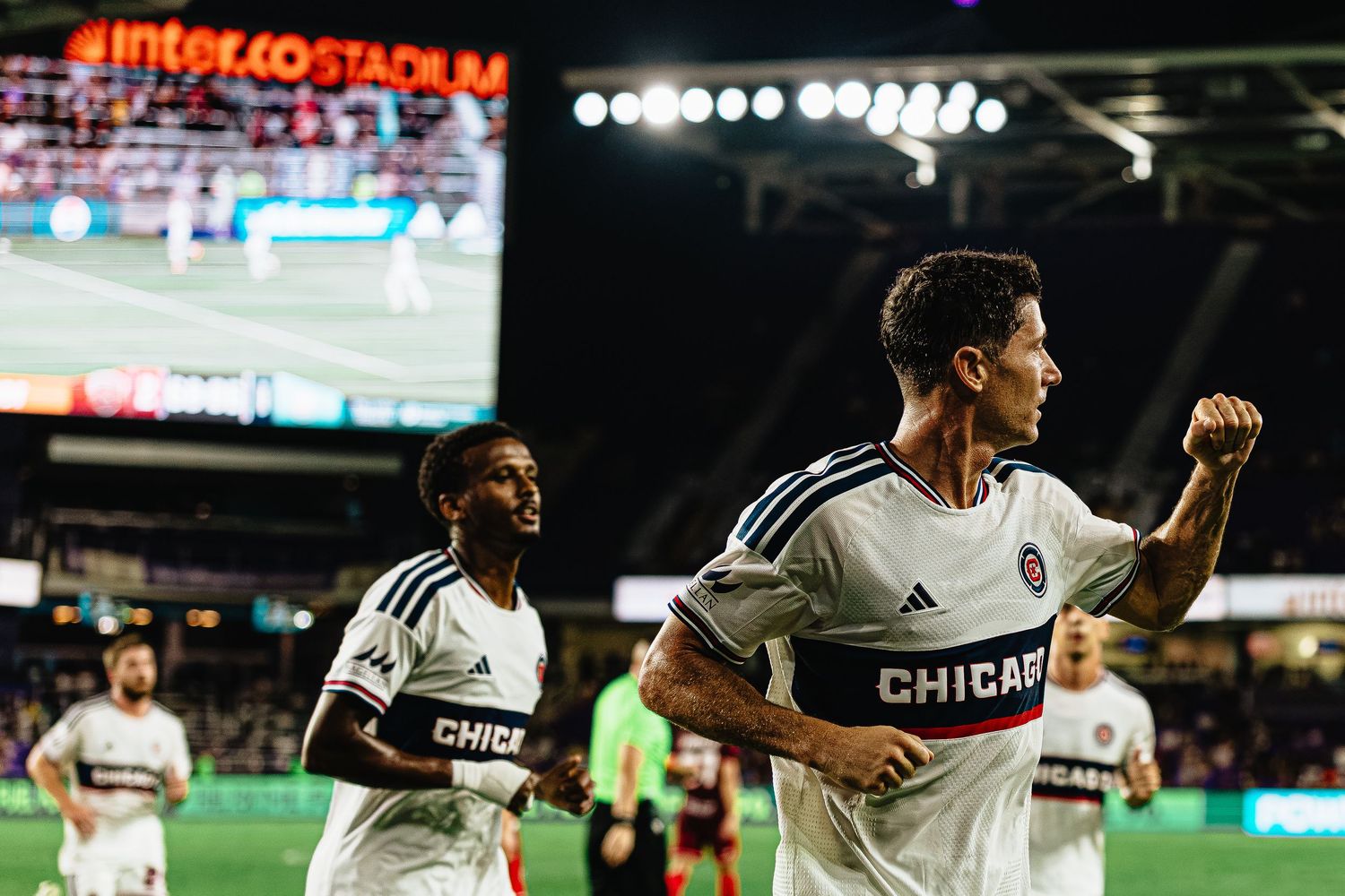 Chicago Fire FC player celebrates a goal at Inter&Co Stadium during an MLS night match.