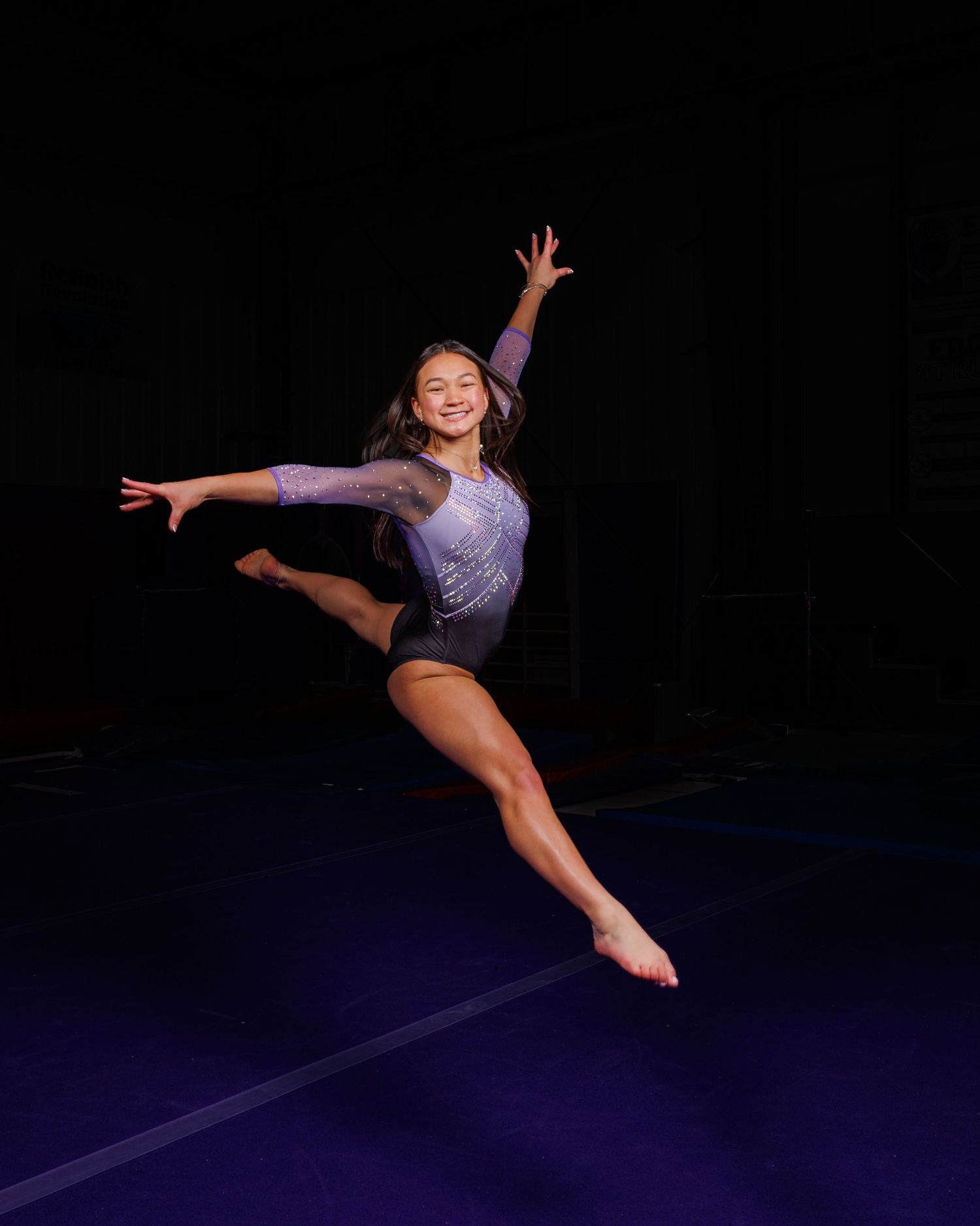 Photo of a female gymnast performing a leap at a gymnastics studio in Riverside | Kansas City Northland Portrait Photographer