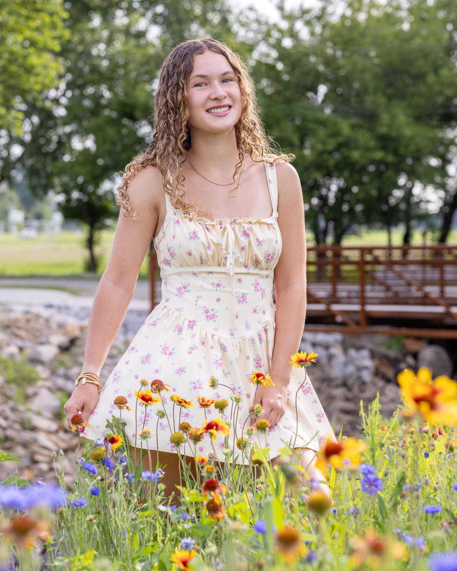 Senior portrait of a young lady standing in flowers at English Landing Park in Parkville | Kansas City Northland Portrait Photographer