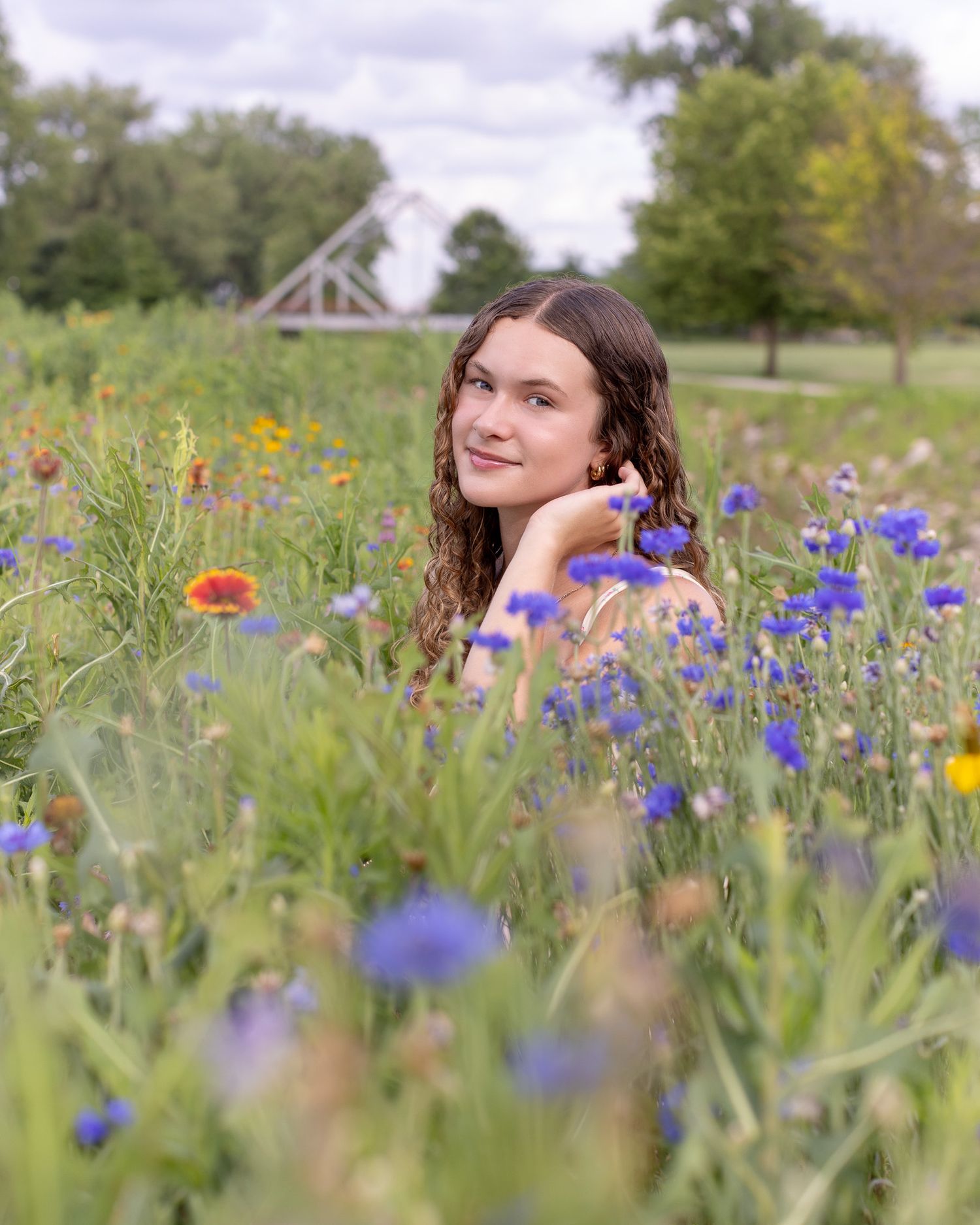 Senior portrait photo of a young lady among the flowers at English Landing Park in Parkville | Kansas City Northland Portrait Photographer