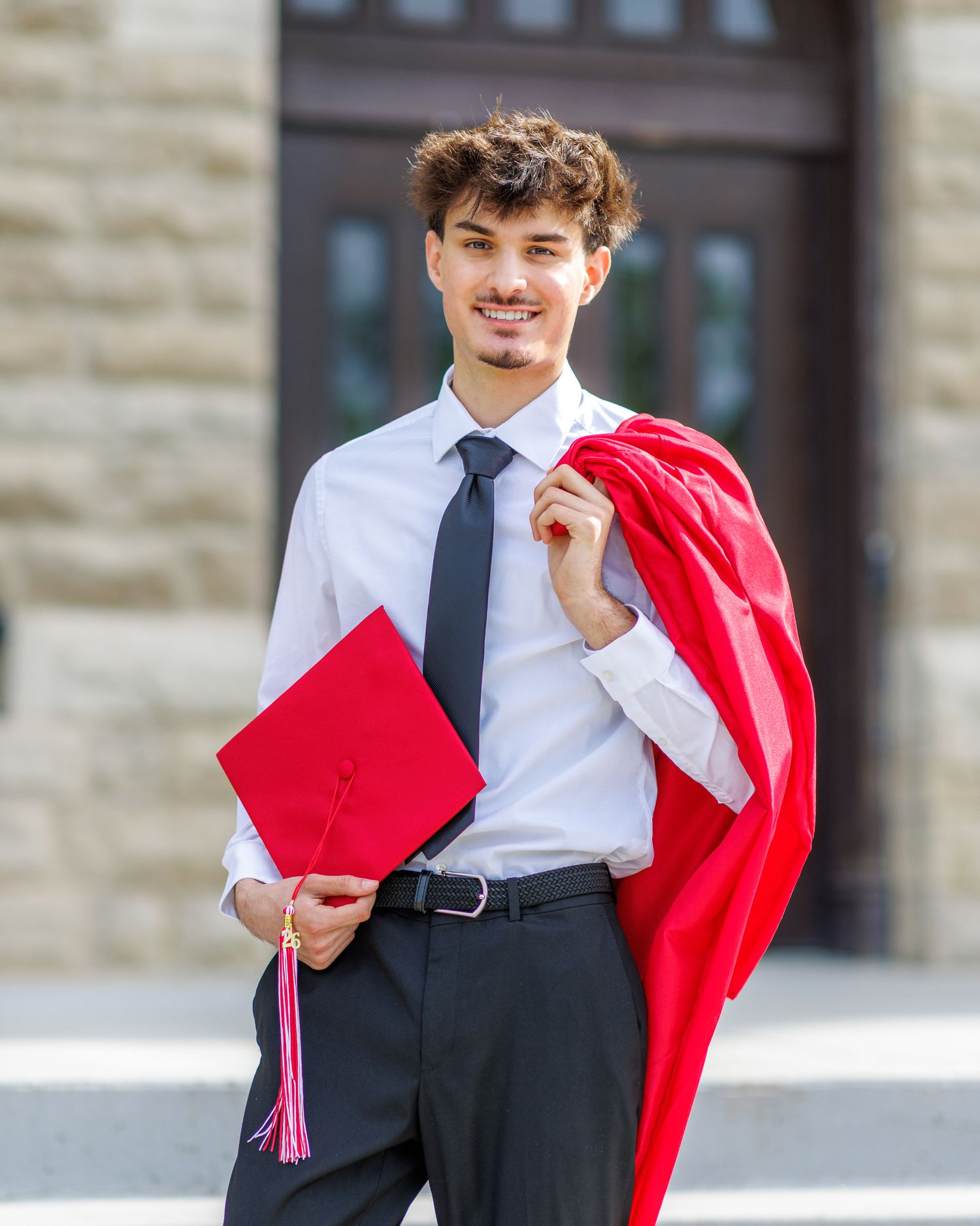 Graduation photo of a young man with his cap and gown at Park University in Parkville | Kansas City Northland Portrait Photographer