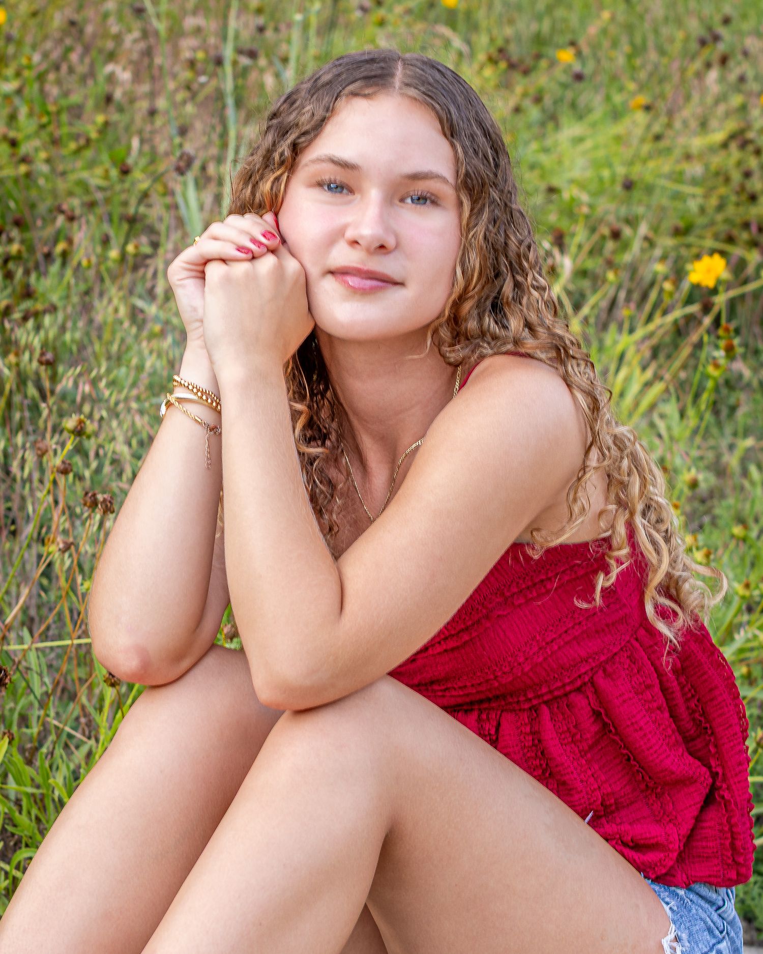 Senior portrait of a young lady sitting on block wall  at Park University in Parkville | Kansas City Northland Portrait Photographer