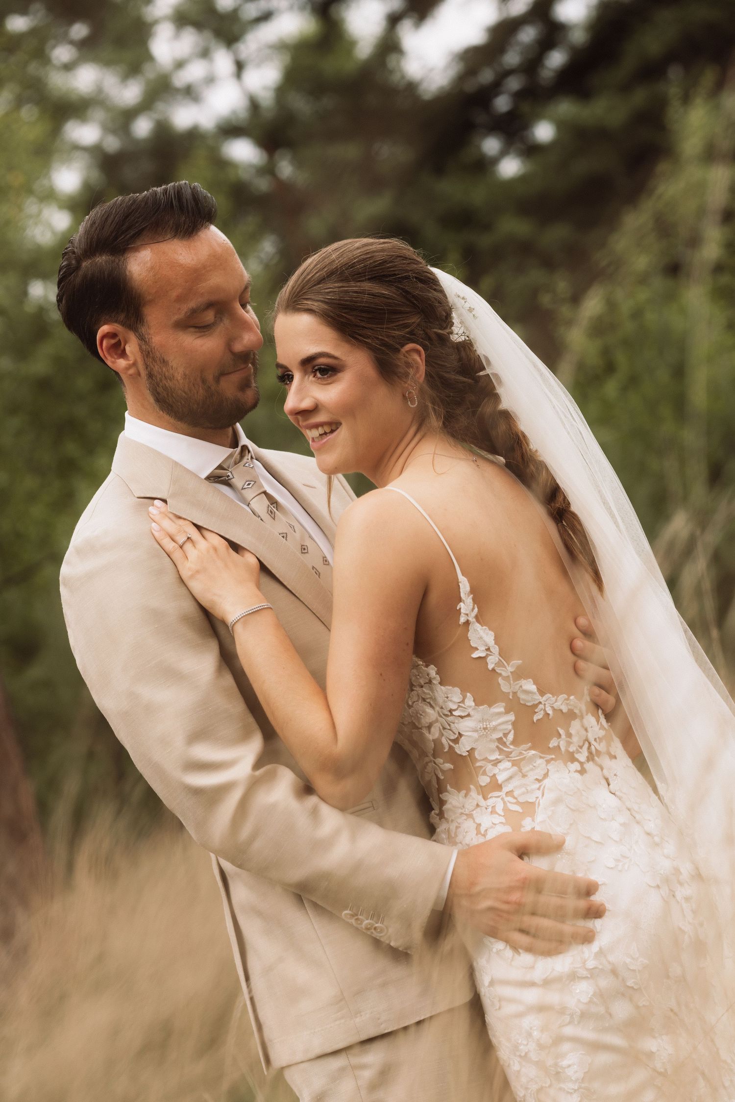 Wedding couple shares tender moments while dancing in a rustic outdoor setting.