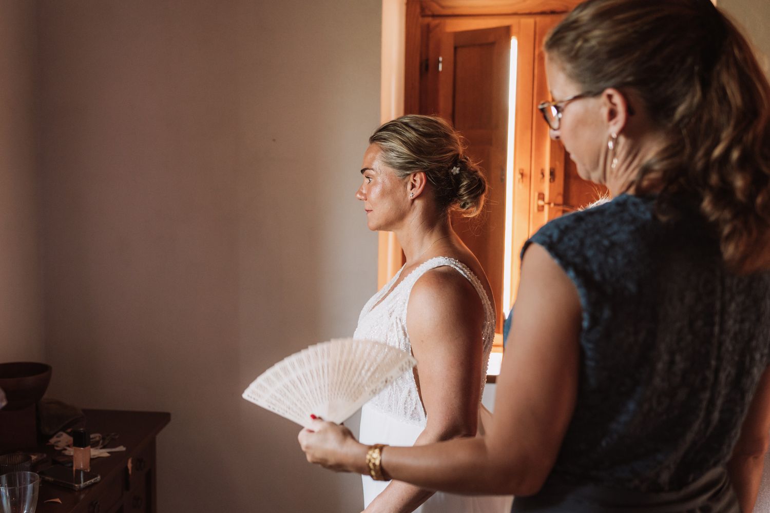 A sequence of wedding preparation photos showing a bride getting ready in a sunlit room.