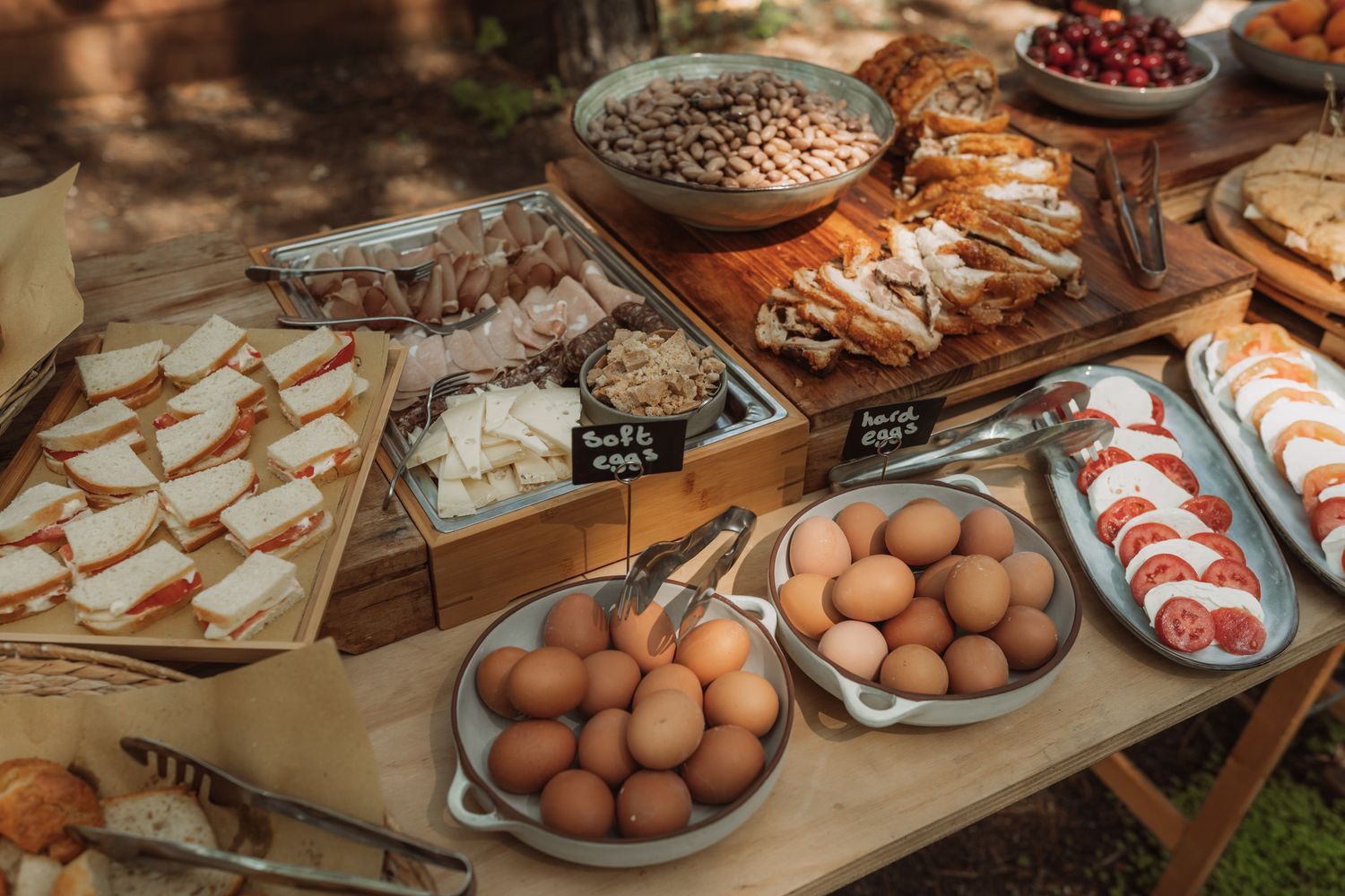 Artisanal bakery counter showcasing fresh bread loaves, eggs, and baked goods on wooden display shelves.