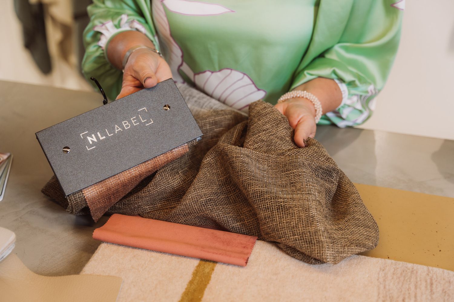 A close-up view of a person holding a brown leather wallet and displaying its various compartments and features.