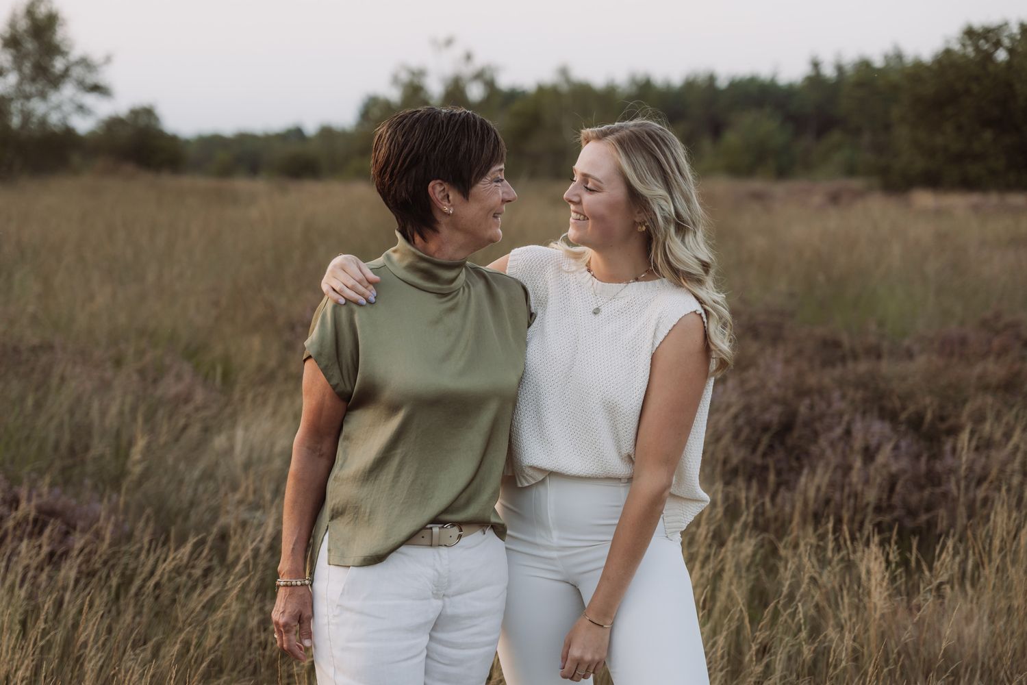 Two people sharing an intimate moment in a rustic field setting.