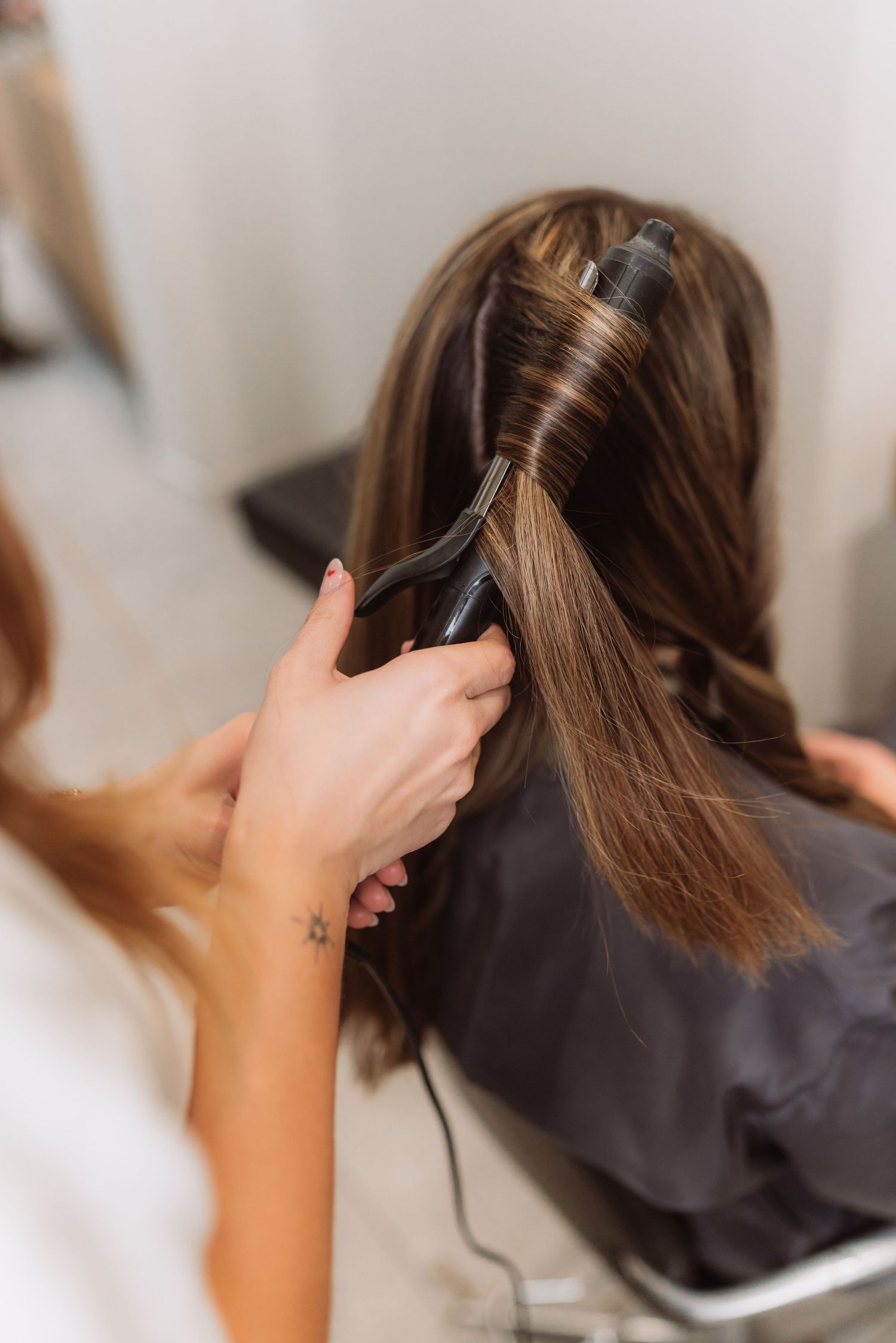 Close-up of hair sectioning technique during salon service.