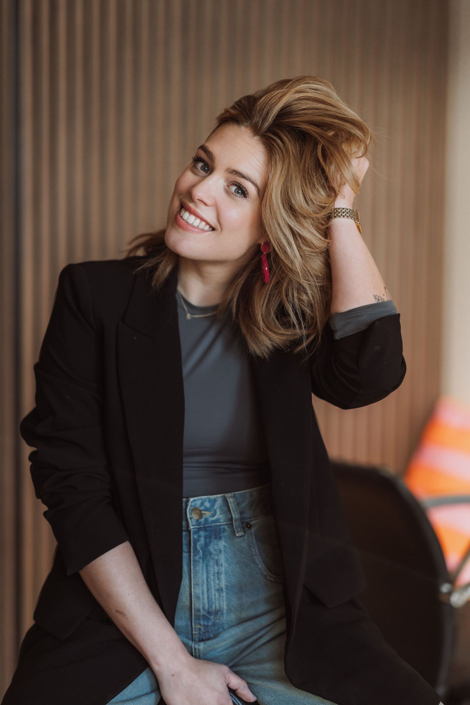 Studio portrait sequence showing dynamic poses in black blazer and denim.