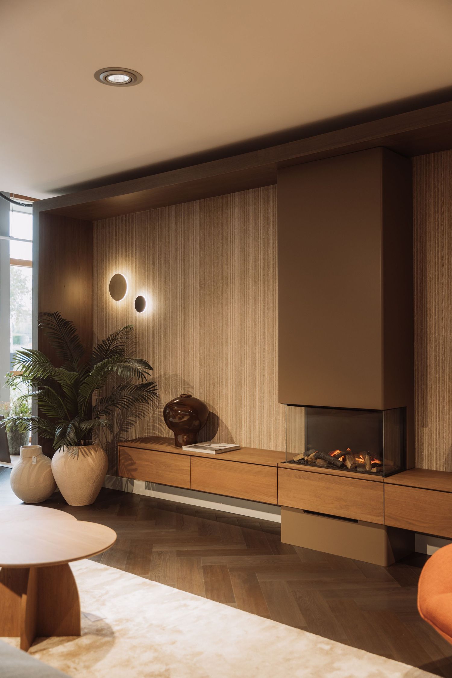 Modern interior design featuring wood paneling, floating shelves, and ambient lighting in a warm brown color scheme.