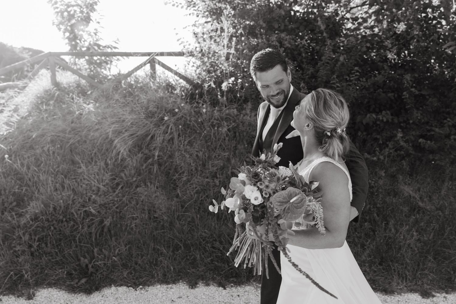 Black and white wedding photo collage showing romantic moments between newlyweds in an outdoor garden setting.