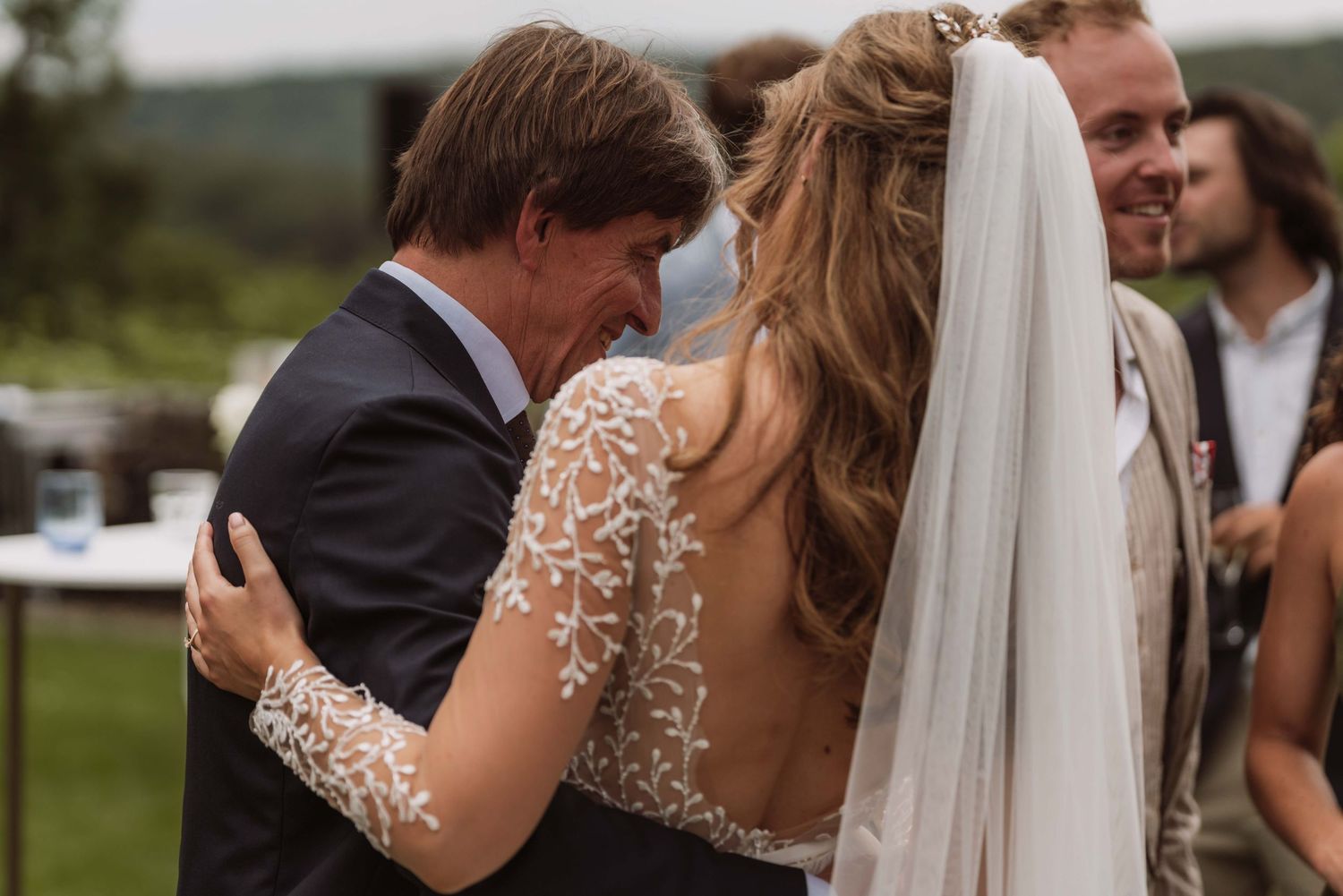 A bride and groom share an intimate moment during their outdoor wedding celebration.