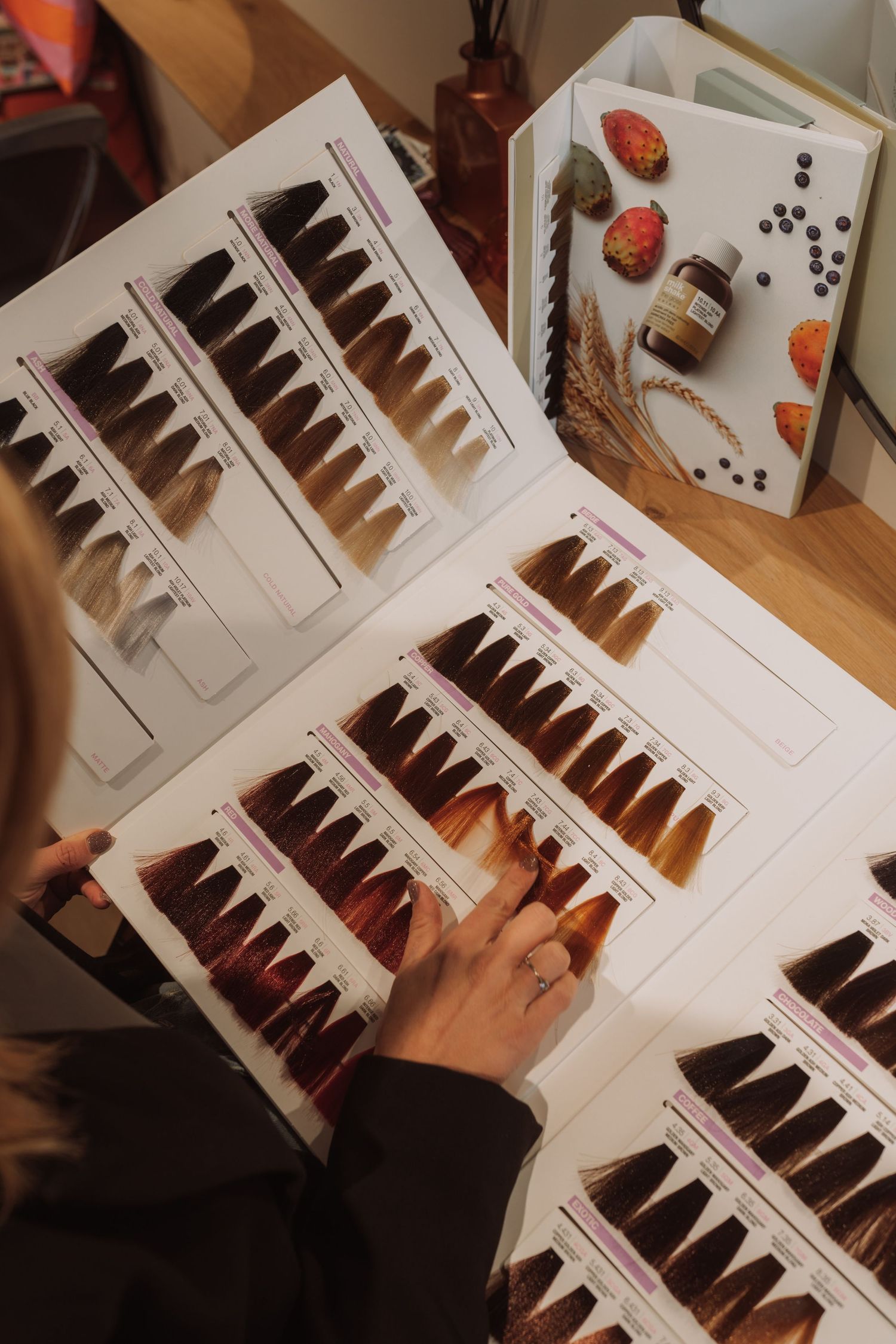 Close-up view of hair color swatches and samples arranged on a white surface.