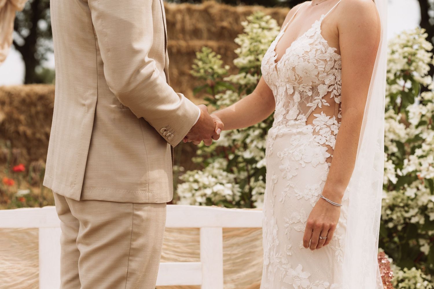 Wedding couple shares intimate moments in their formal attire against natural backdrop.