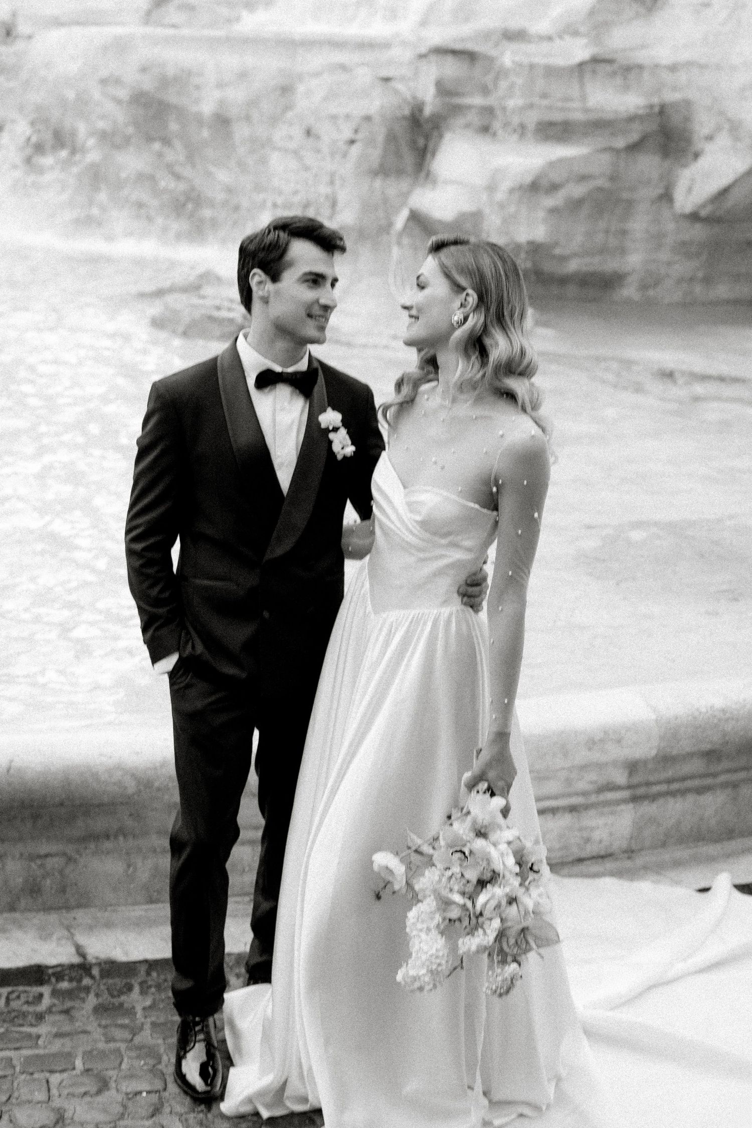 Black and white wedding portraits captured in an elegant outdoor setting.
