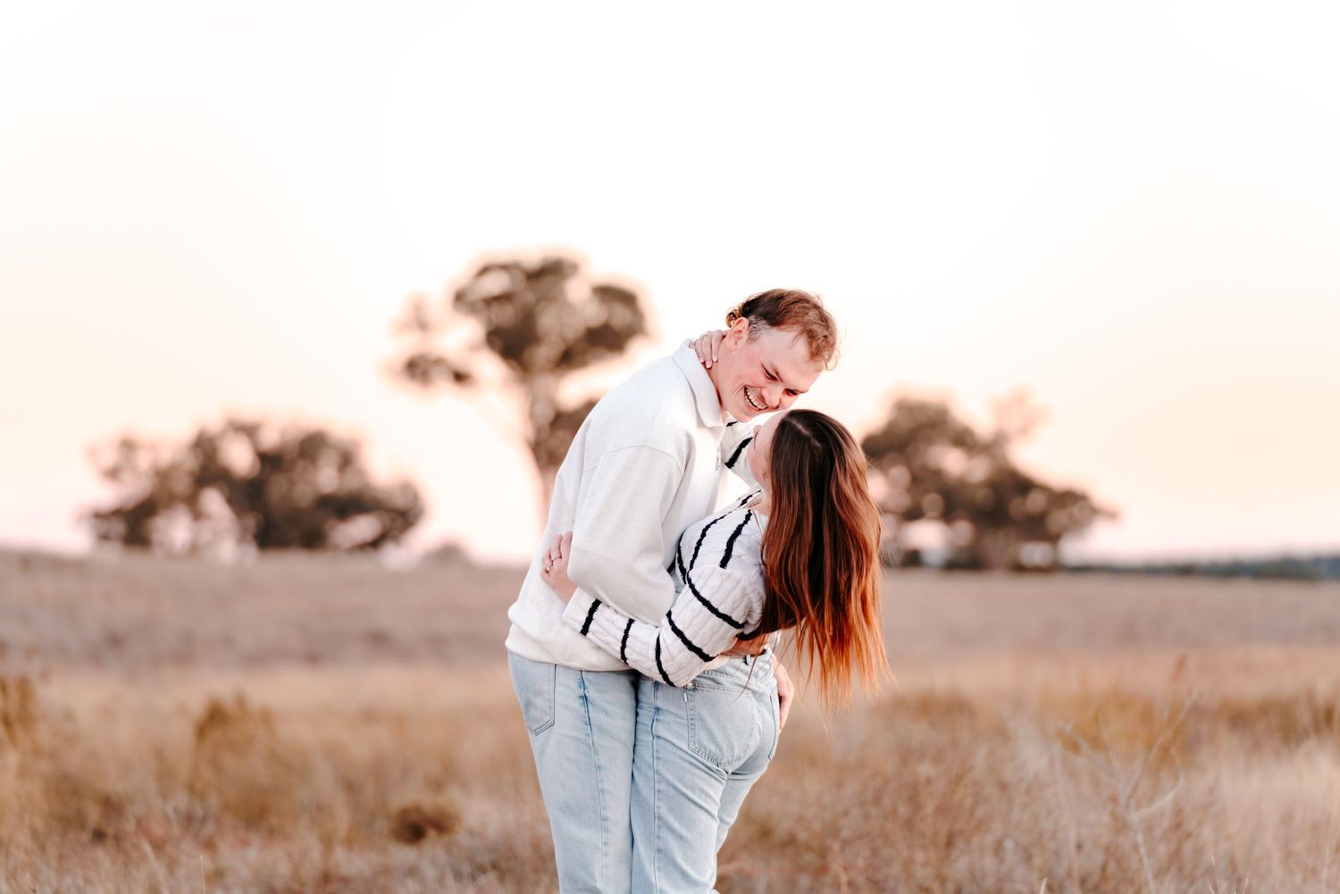 a young, playful couple enjoying a couples session where they are connecting through playful prompts and movement