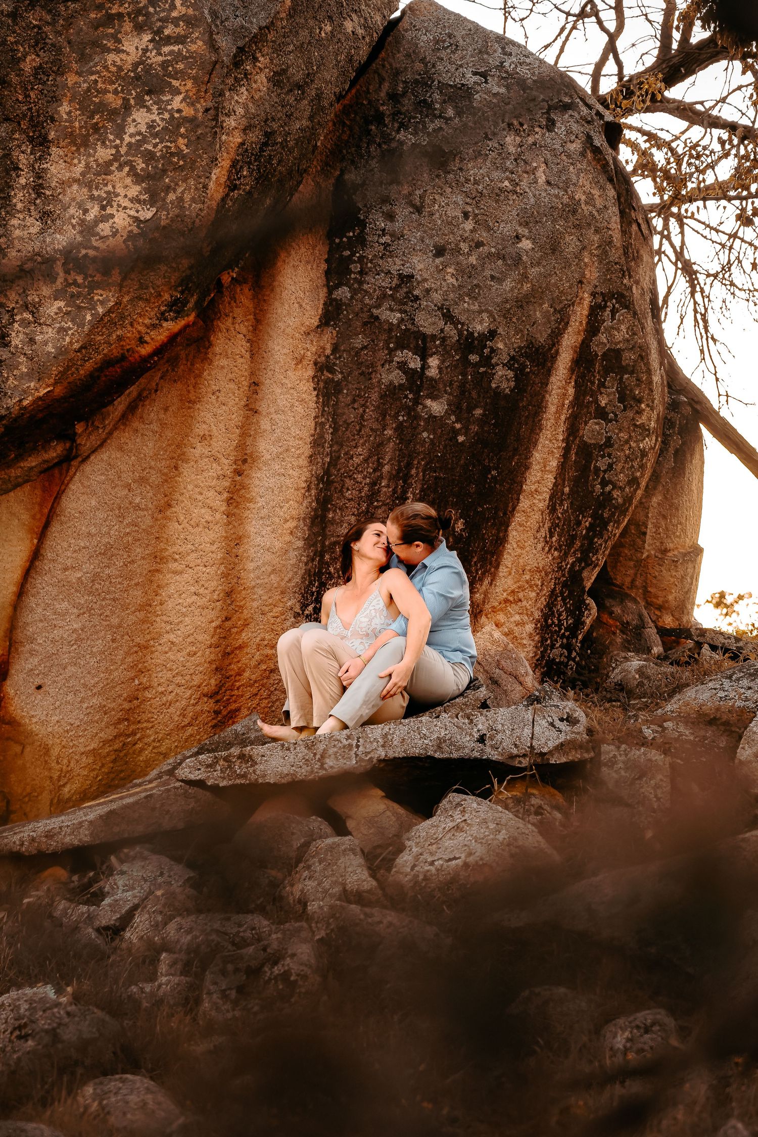 beautiful dramatic rock backdrop with a female couple sitting and enjoying an intimate moment
