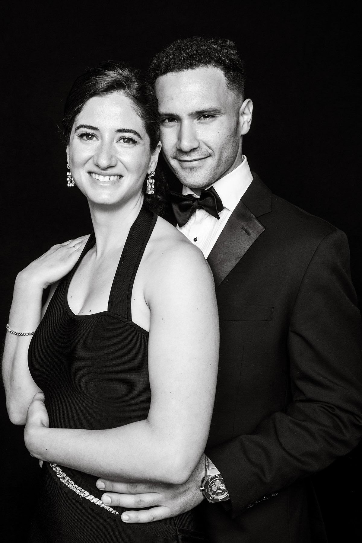 Dramatic black and white couple photos featuring elegant formal wear and intimate poses.