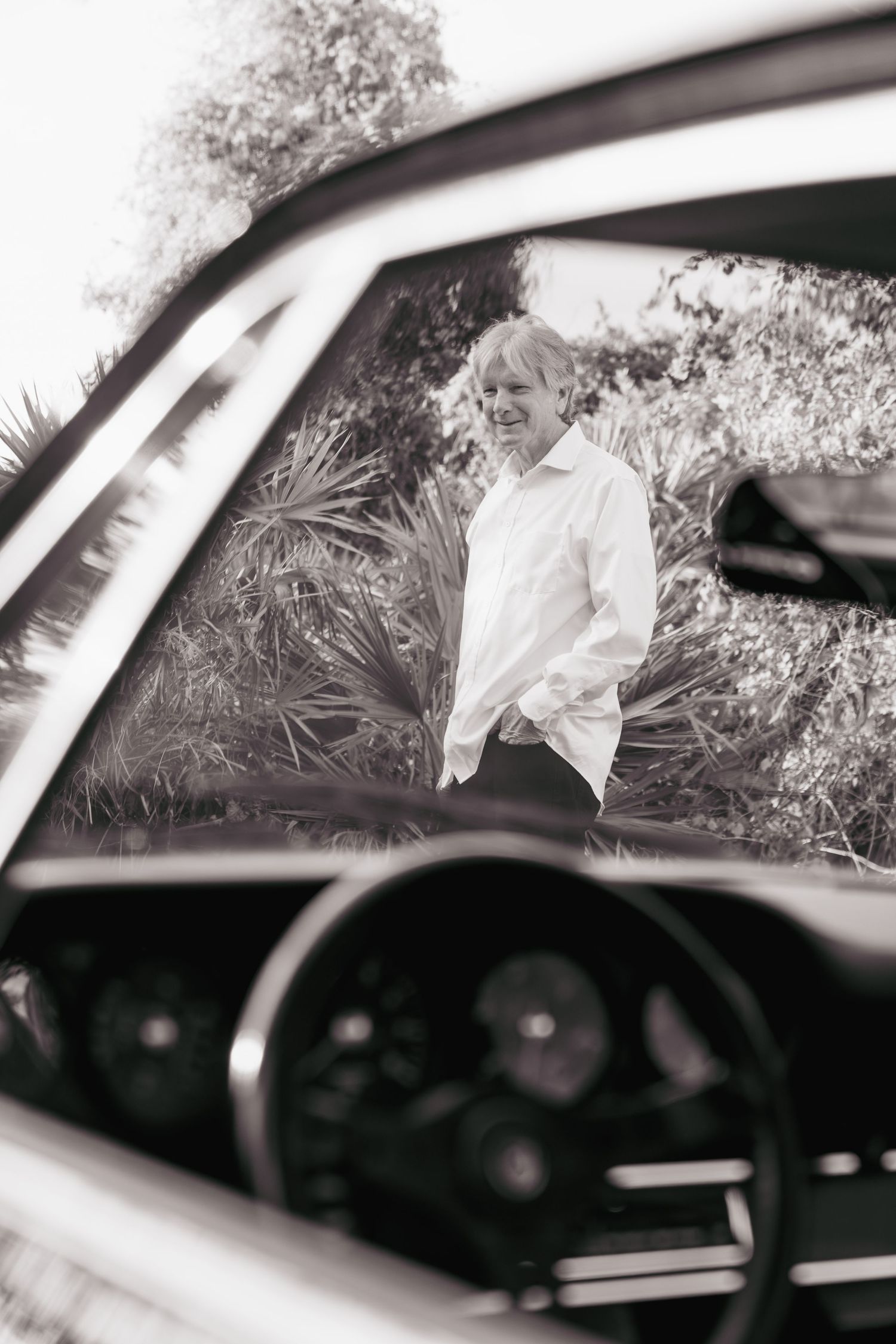 Black and white photo series showing a car interior with white veil fabric flowing through the window.