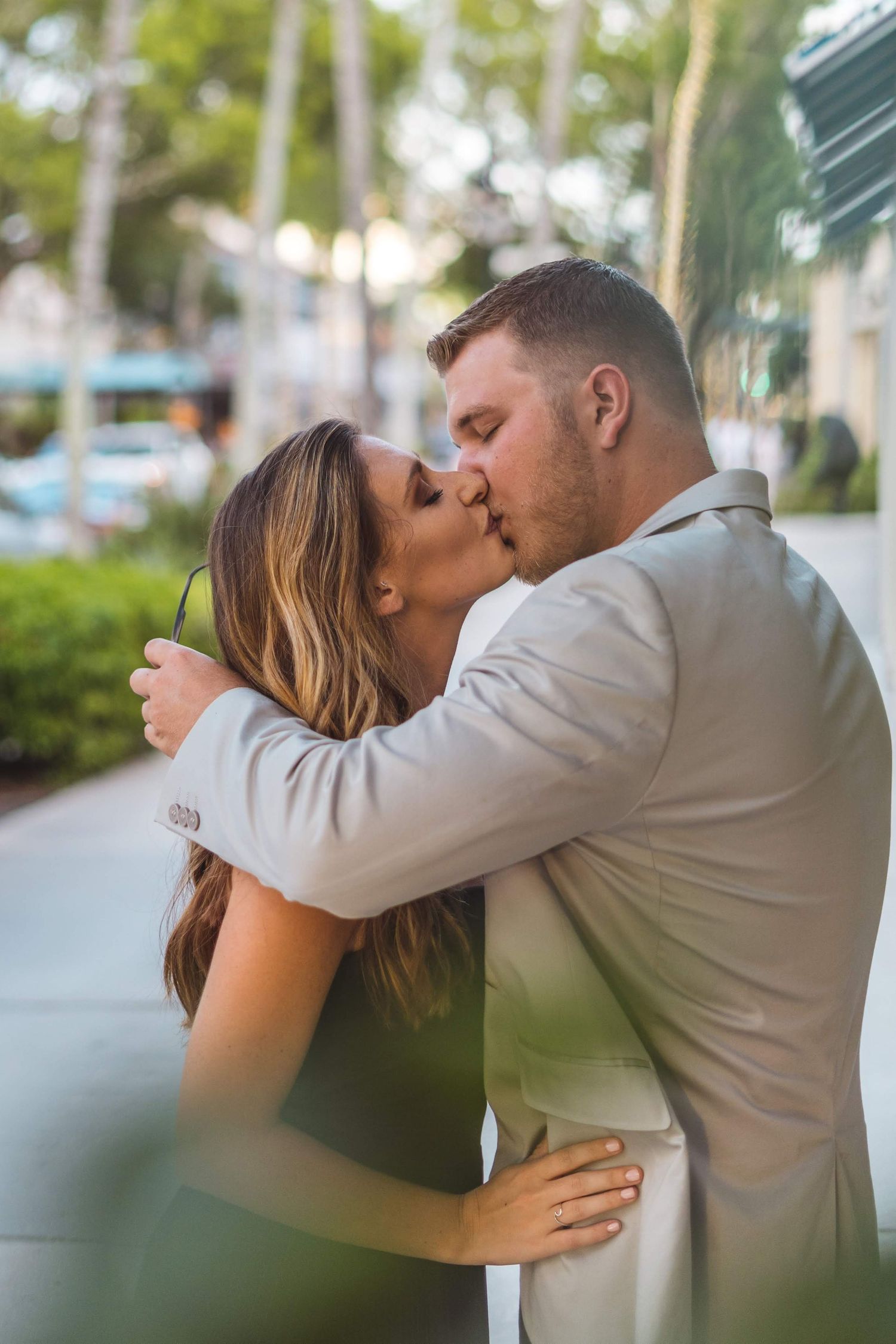 A romantic sequence of a couple sharing intimate kisses in an outdoor setting.
