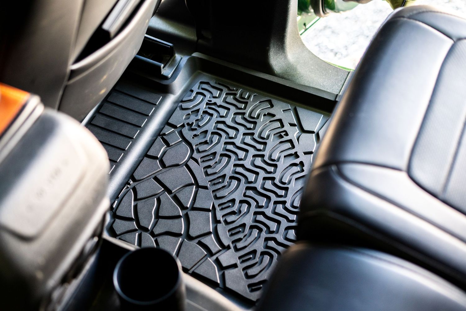 Close-up of textured black rubber floor mats with geometric pattern design.