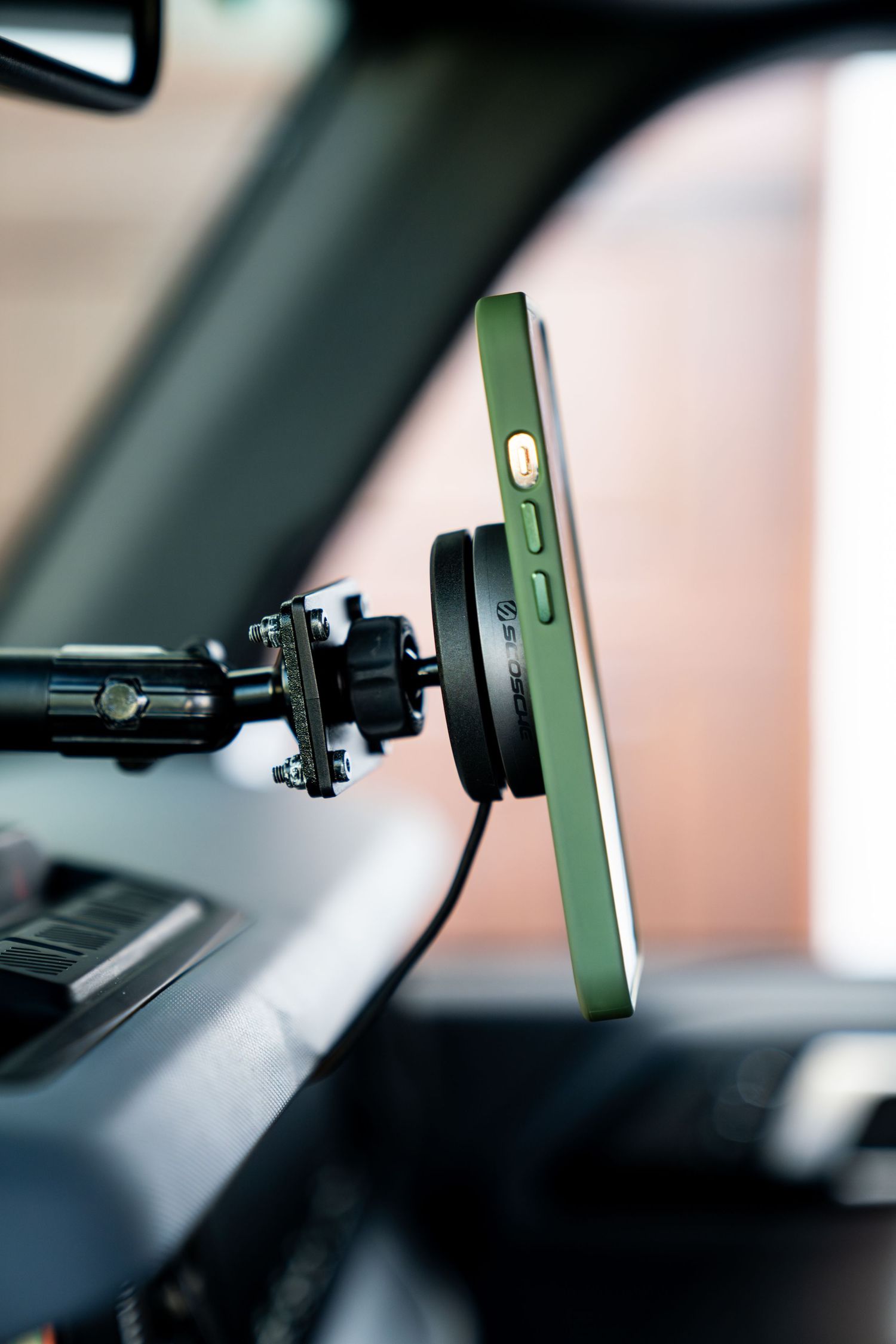 Close-up of adjustable phone mount installed on vehicle dashboard.