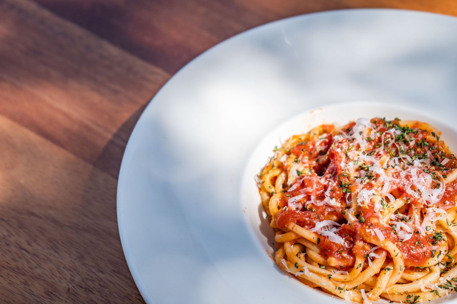 Sequence of pasta dishes on white plates showing progressive eating stages from full to empty.