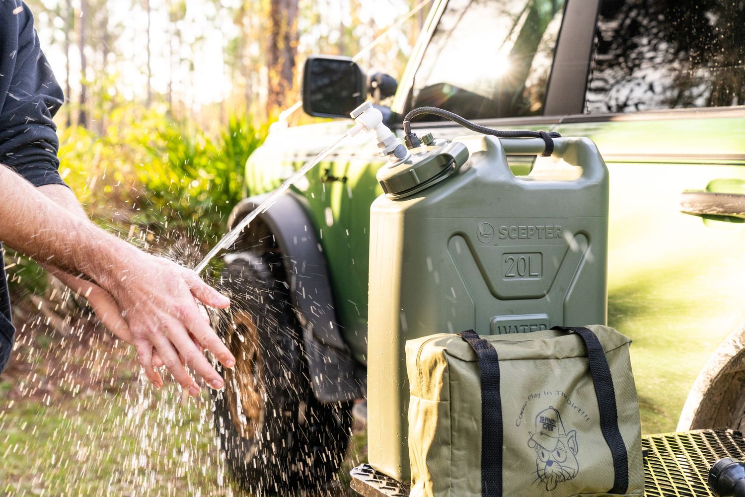 Green jerry cans mounted on vehicle exterior racks for fuel or water storage.