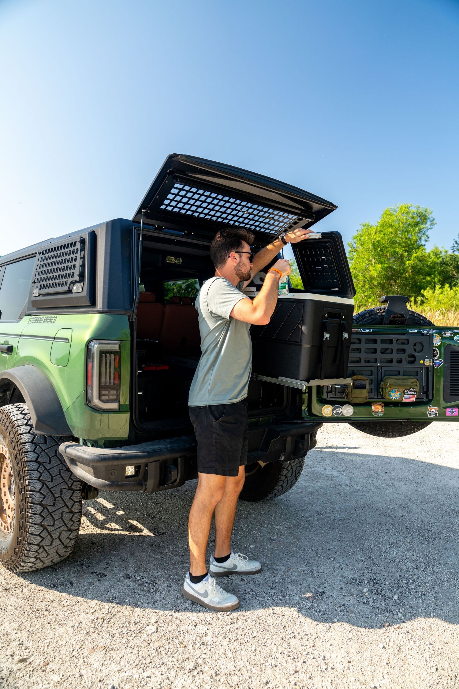 View of truck cargo area with black protective bedliner and tailgate open.