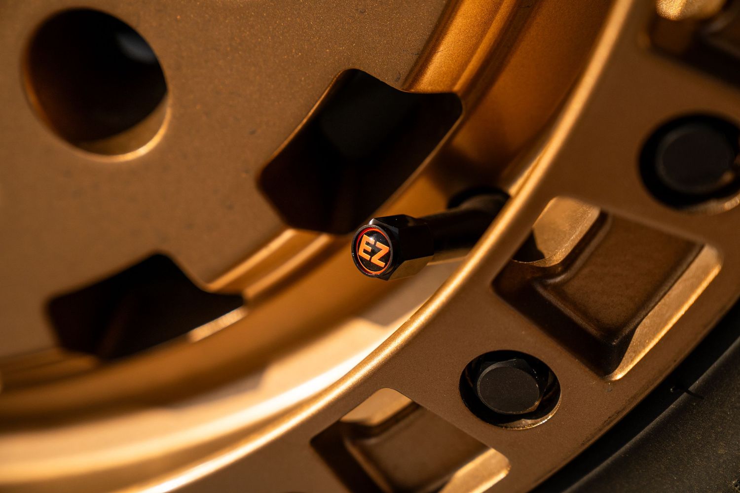 Close-up detail of bronze-colored automotive wheel rim texture.