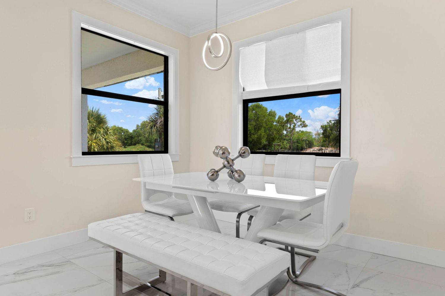 Modern white bedroom interior with large windows and minimalist decor showcases clean lines and natural light.
