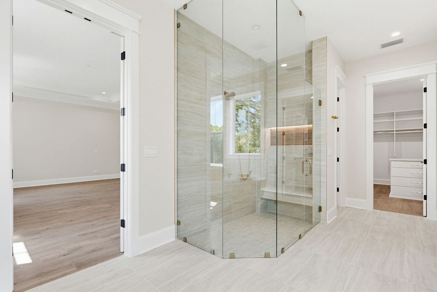 Modern white interior hallway with glass walls, wooden flooring, and minimalist design features creates a bright open space.