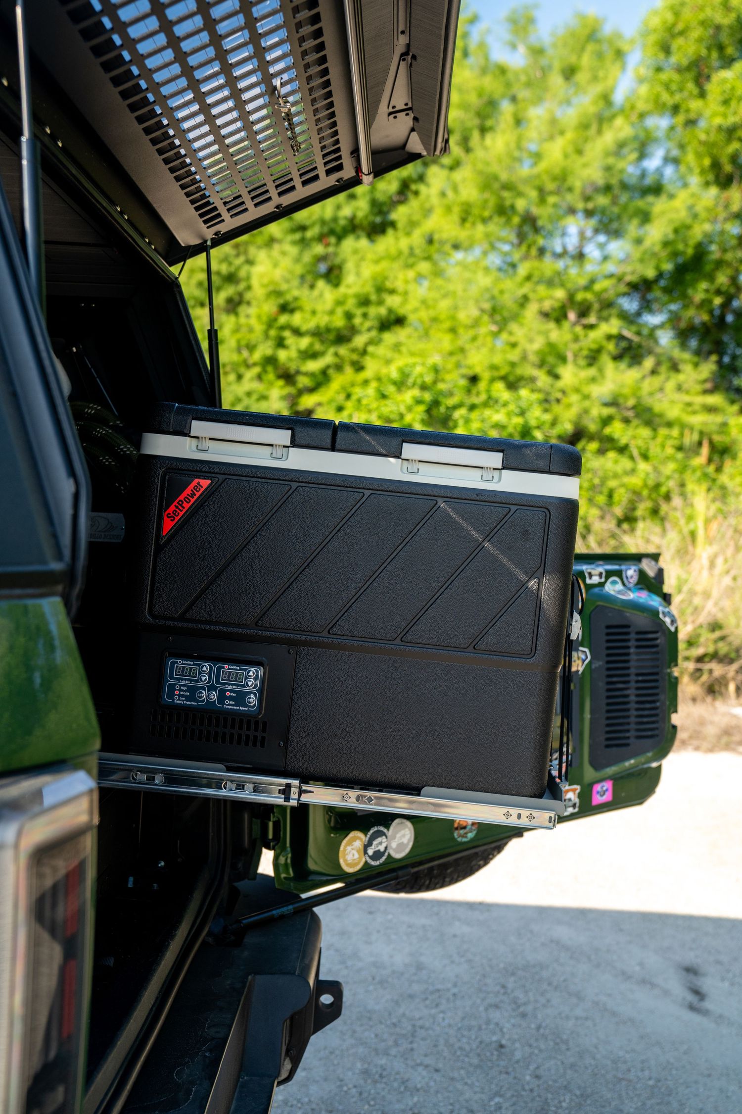 Black electronic equipment mounted inside a vehicle showing modular components.