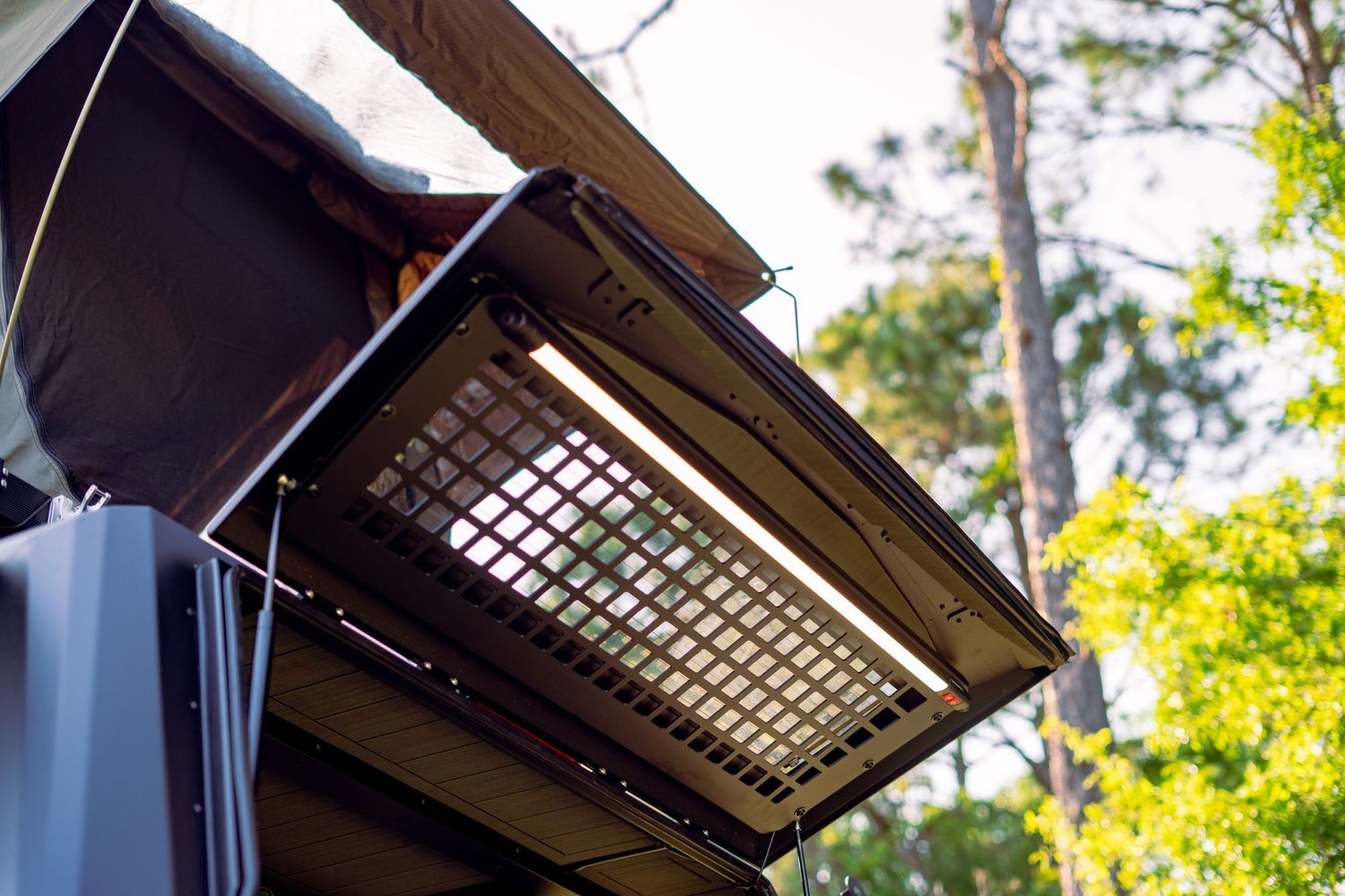Vehicle roof rack with integrated LED light bar system mounted on top.