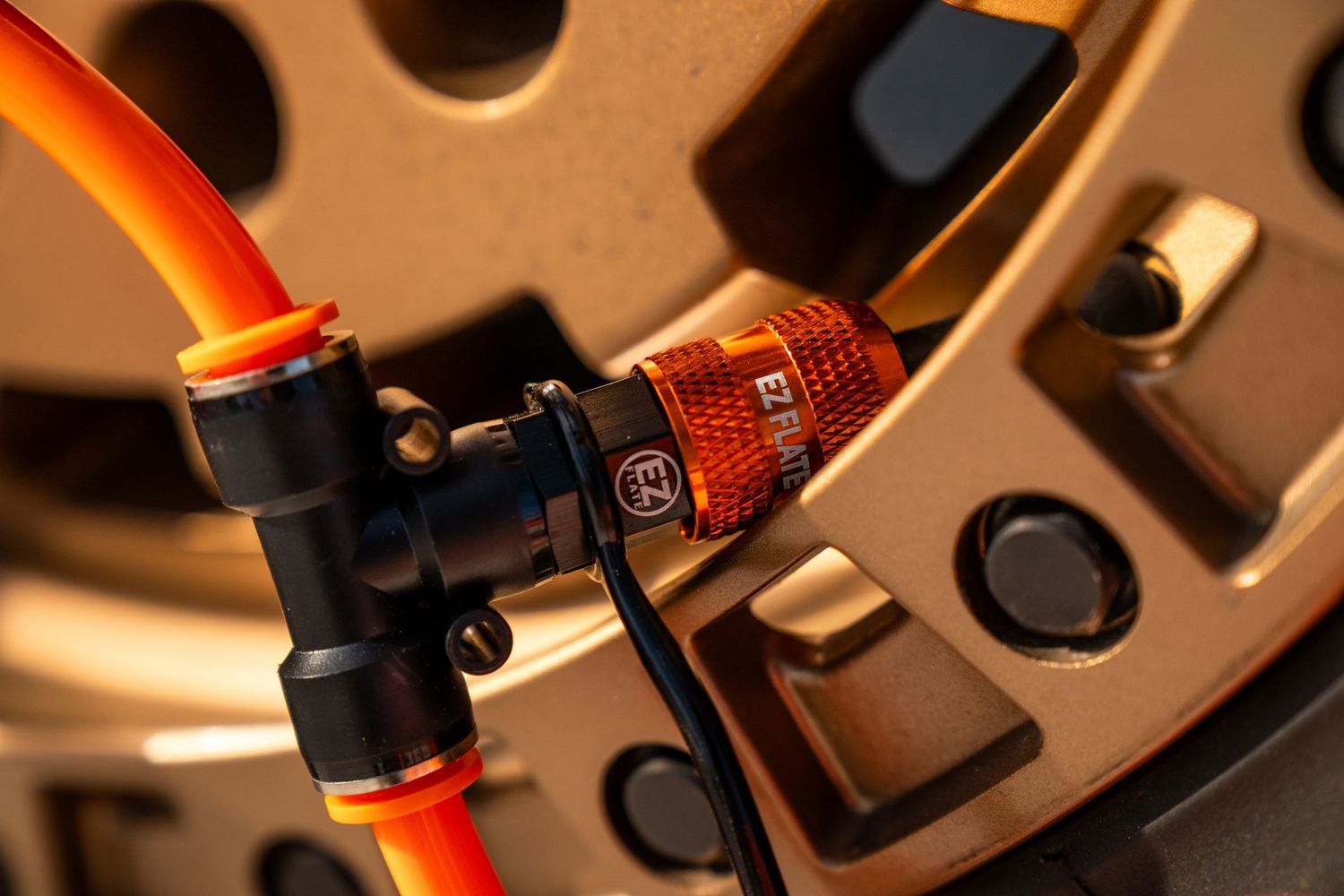 Macro shot of orange and black mechanical components with circular patterns.