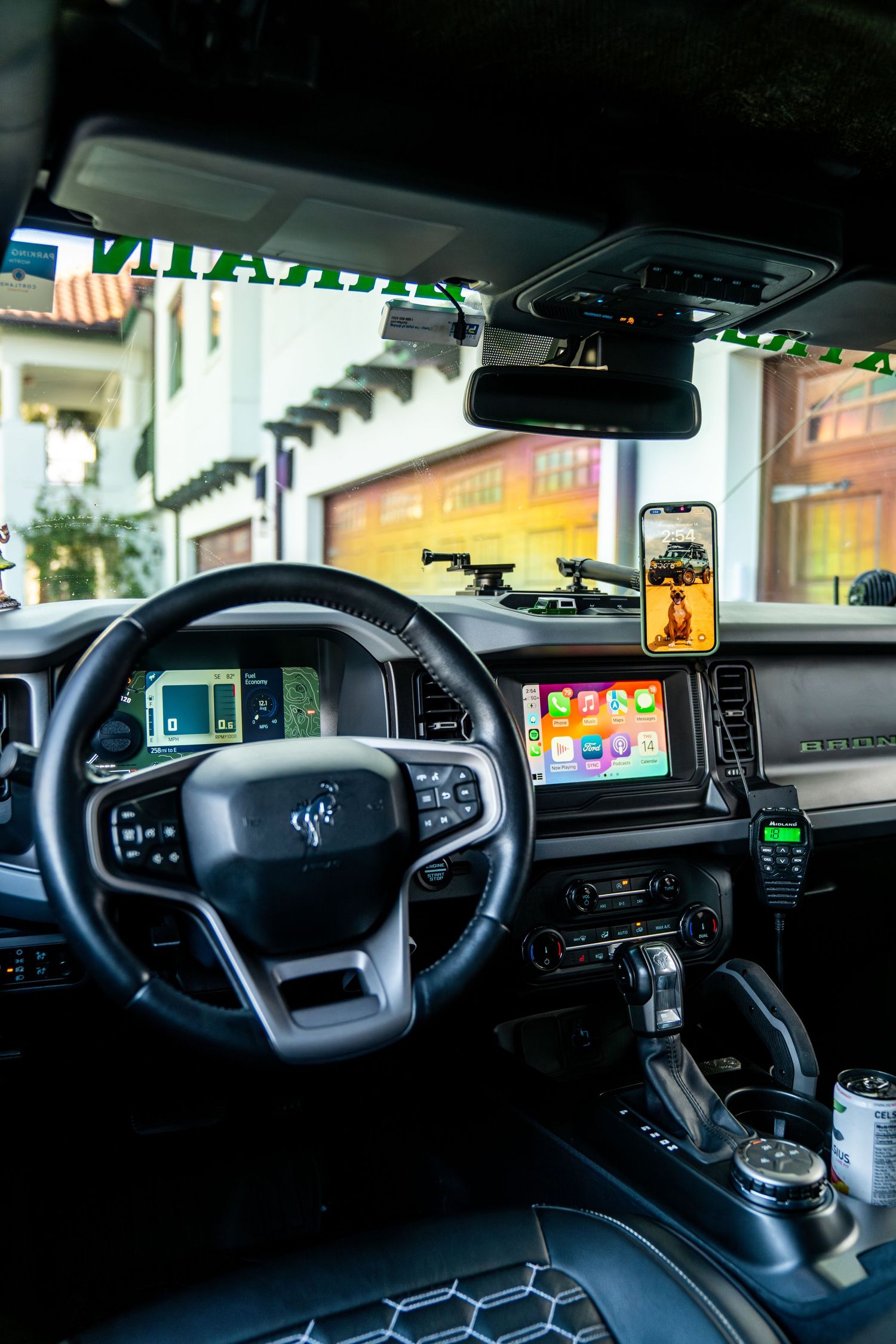 Modern vehicle dashboard with digital displays and control interfaces.