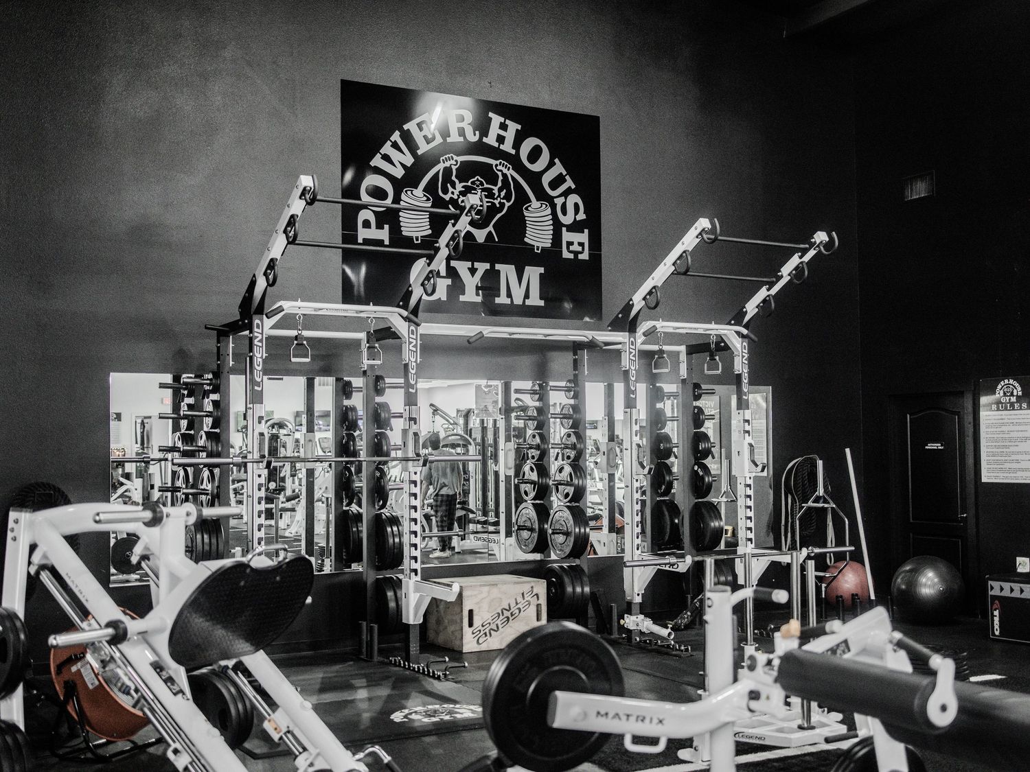 A vintage black and white photo montage shows various gym equipment and workout machines in a fitness facility.