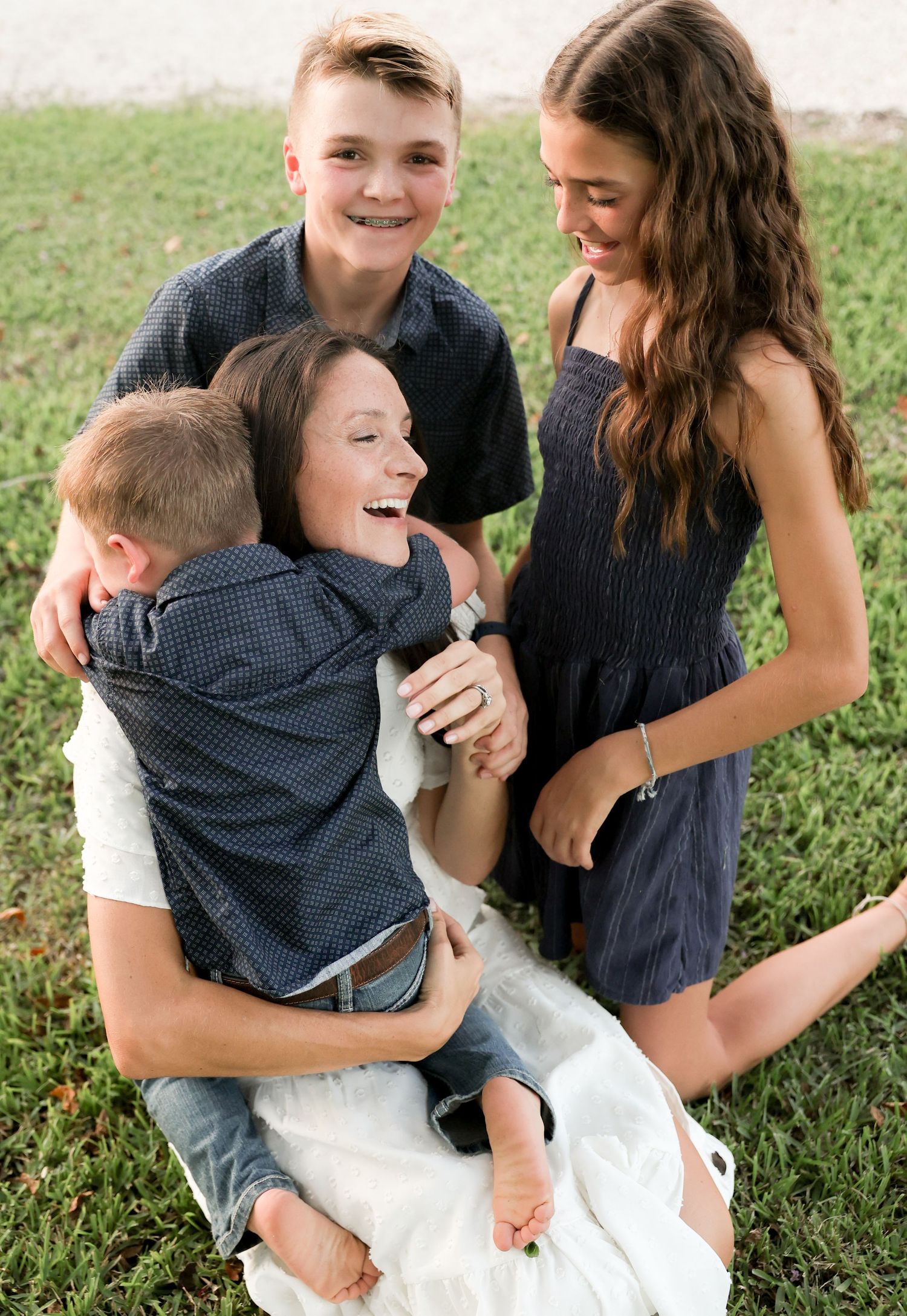 family hugging and cuddling with mom outdoor family photos