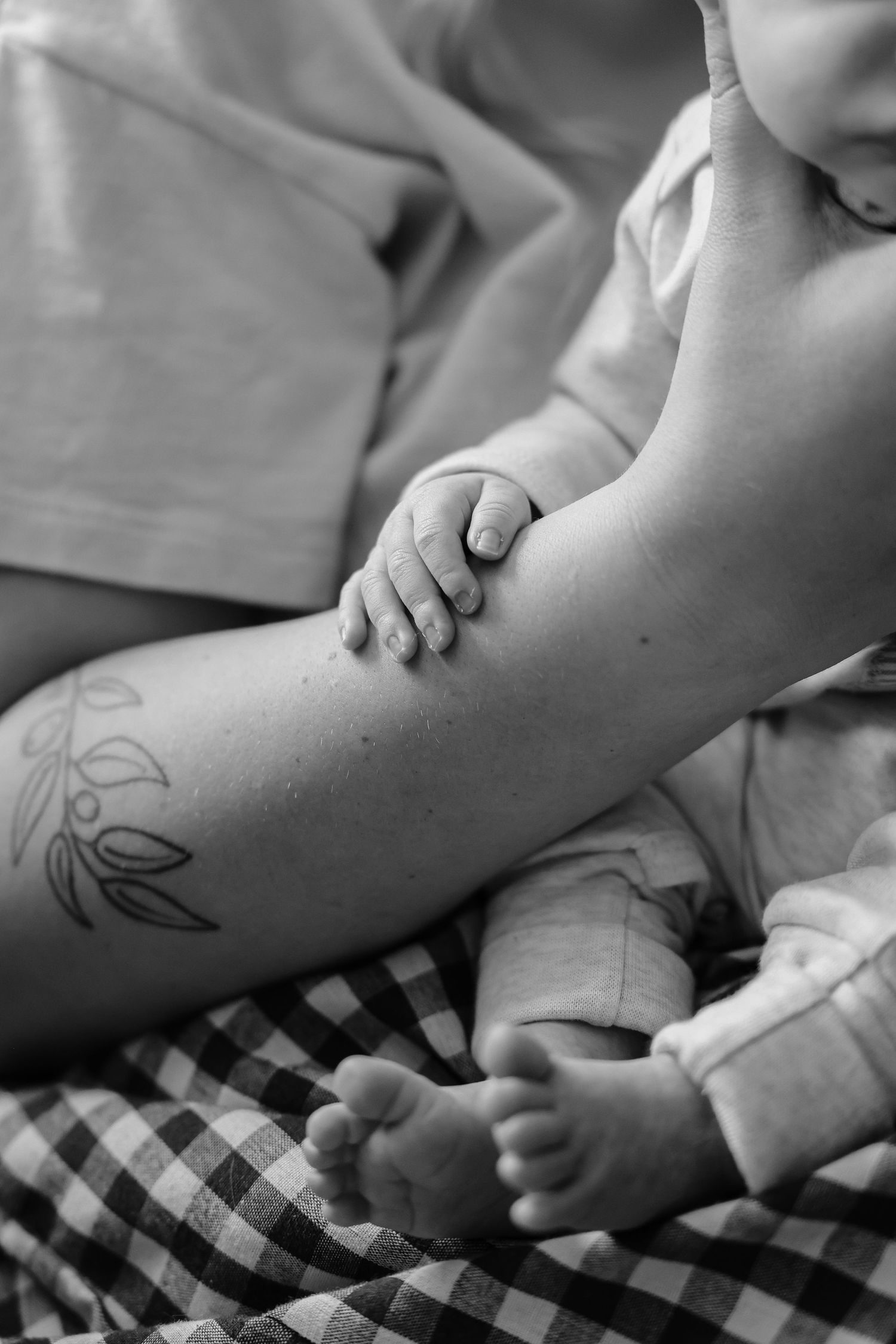 newborn baby hand gripping mom's arm