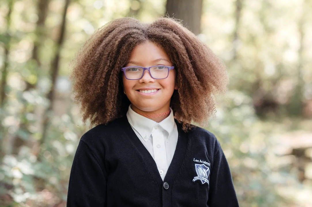 School portraits featuring students in matching uniforms with a forest backdrop.
