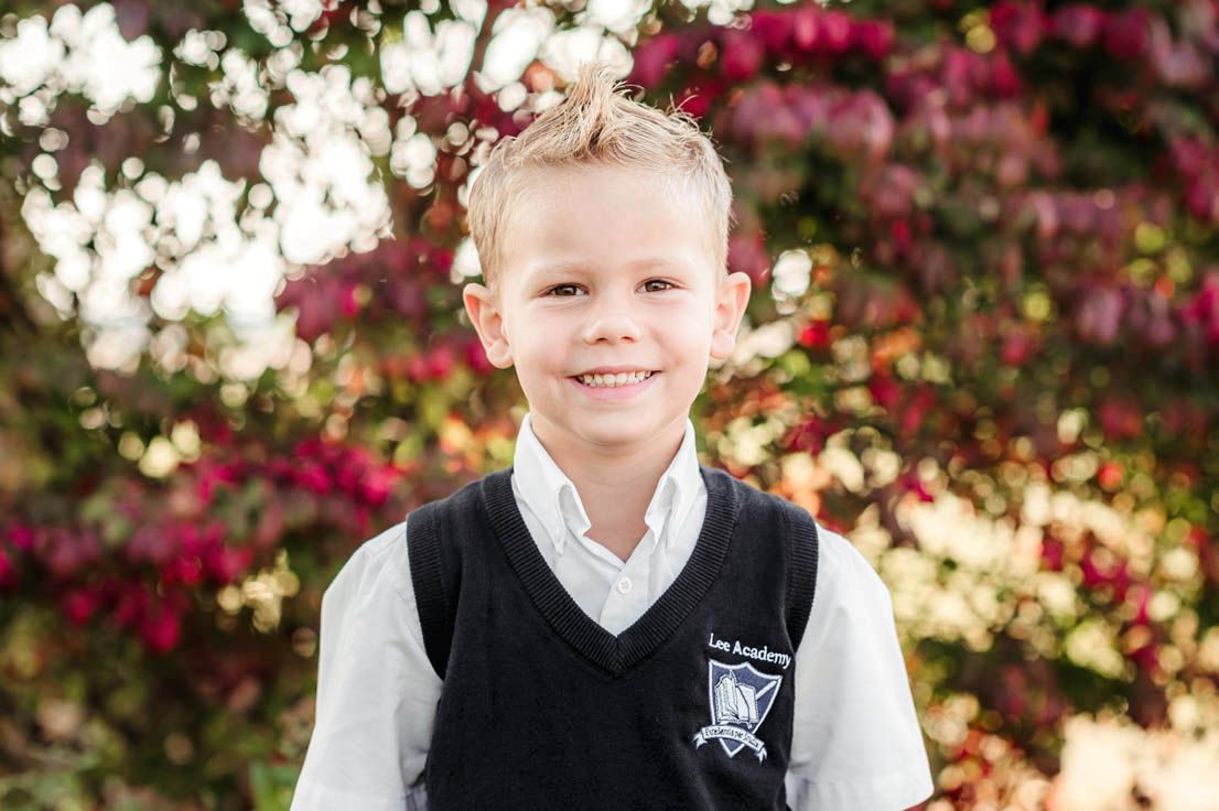 School portrait series featuring students in matching black vests with school emblems.