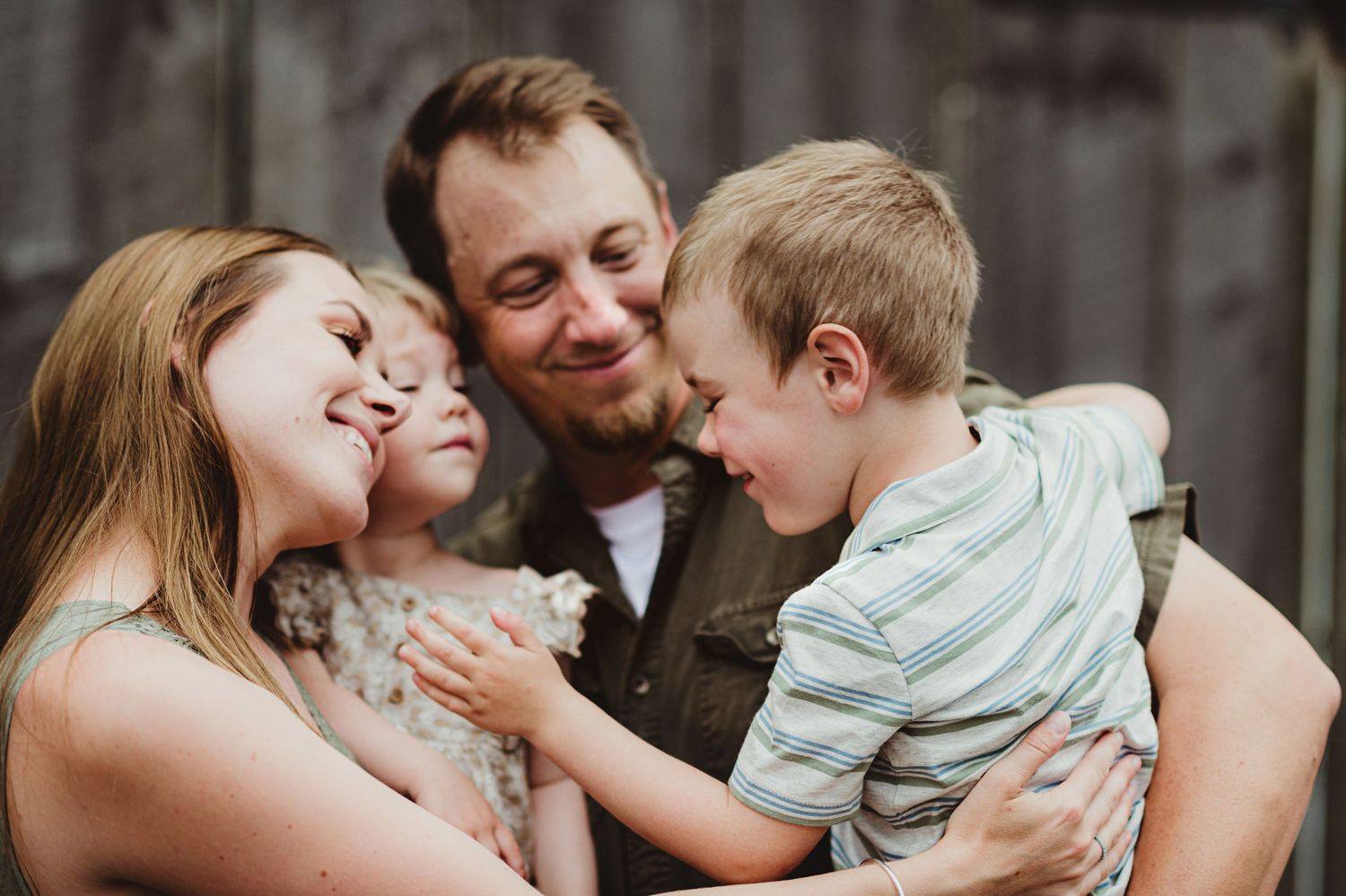 A tender family moment captured during a lifestyle photo session outdoors.